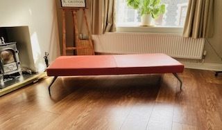 Mid Century Danish Style Long Bench. Orange Vinyl Upholstery And Stainless Steel Legs. Orangebox.