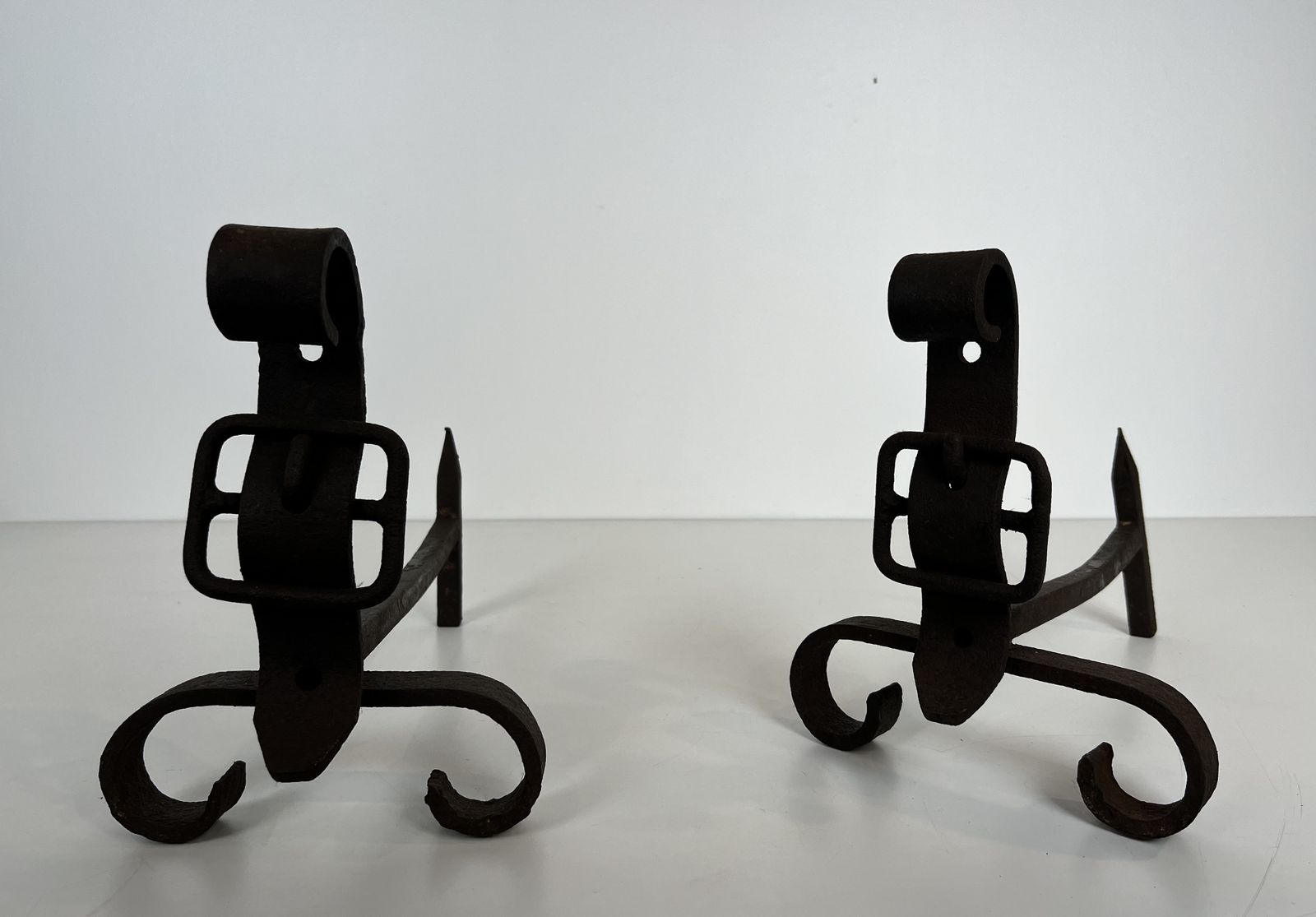 Pair Of Modernist Andirons Representing A Belt photo for sale