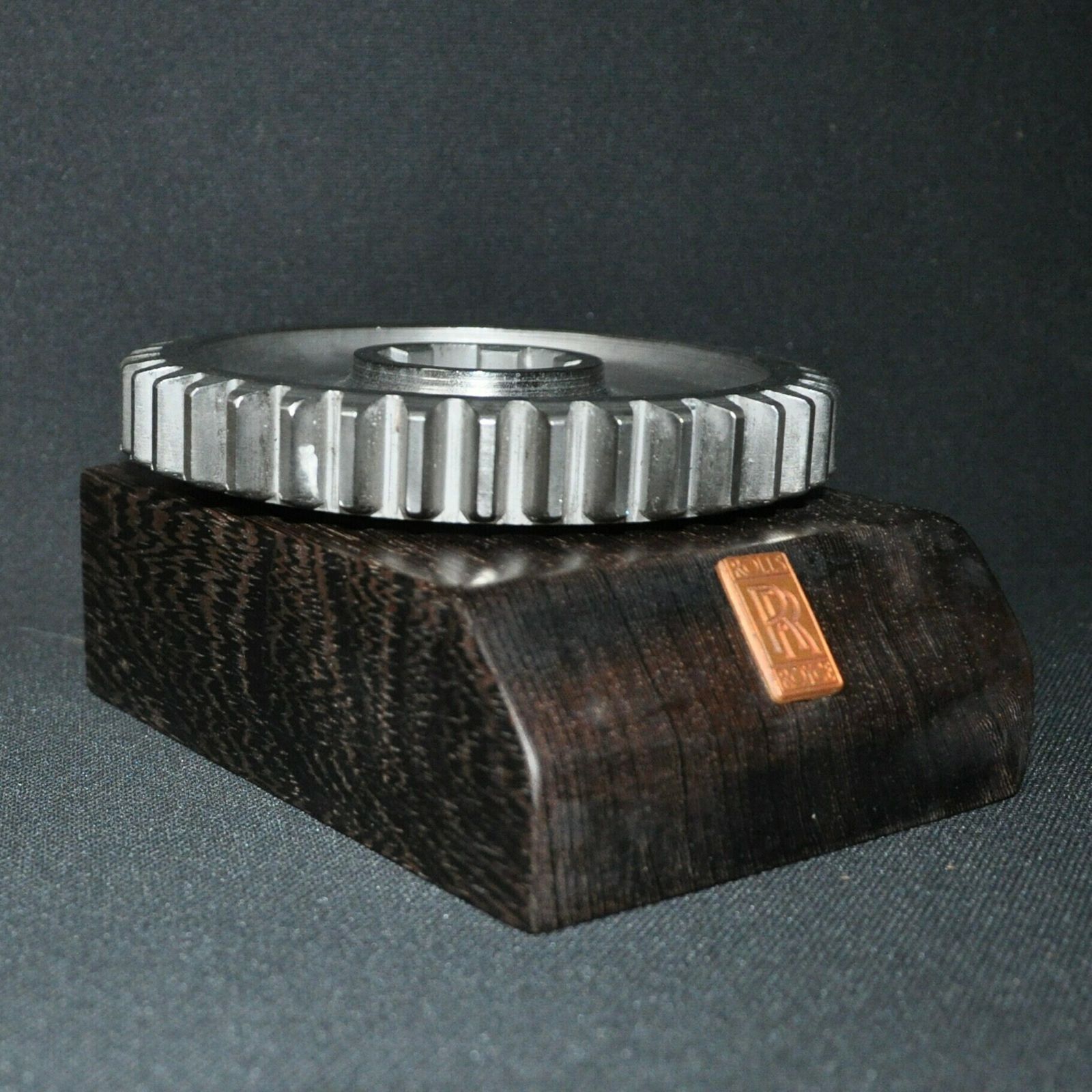 Rolls Royce Car Engine Gear On Hard Wood Base photo furniture