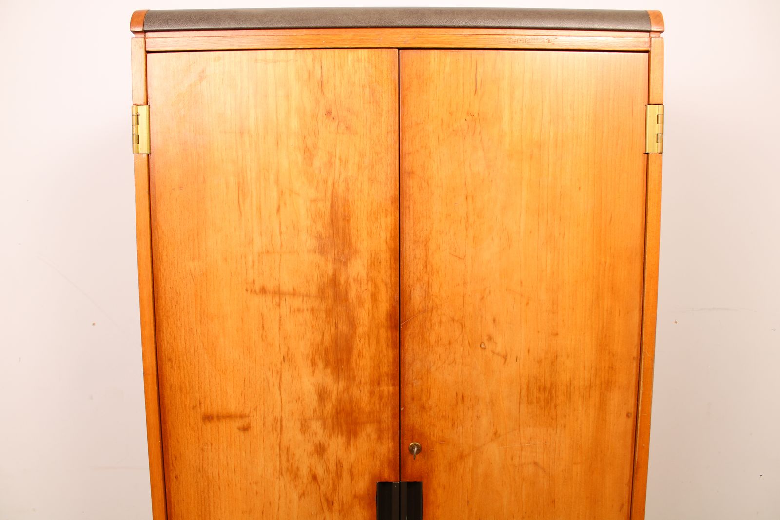 A Vintage Mid Century Cupboard, With Faux Leather Top And Recessed Metal Handles photo buy
