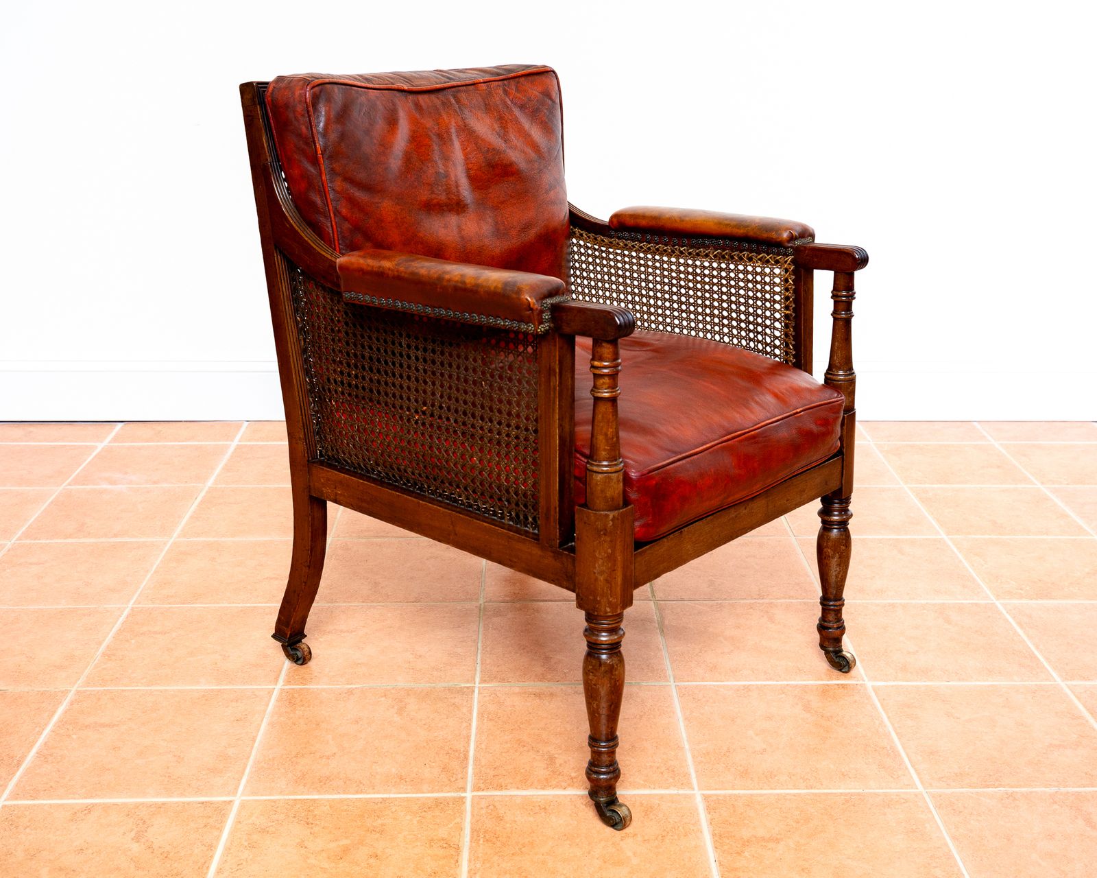 Fine Regency Bergere Leather Library Chair 1810 1820 Georgian Reading Red Leather Armchair Carved Cane Rattan Brass Castors photo vinterior
