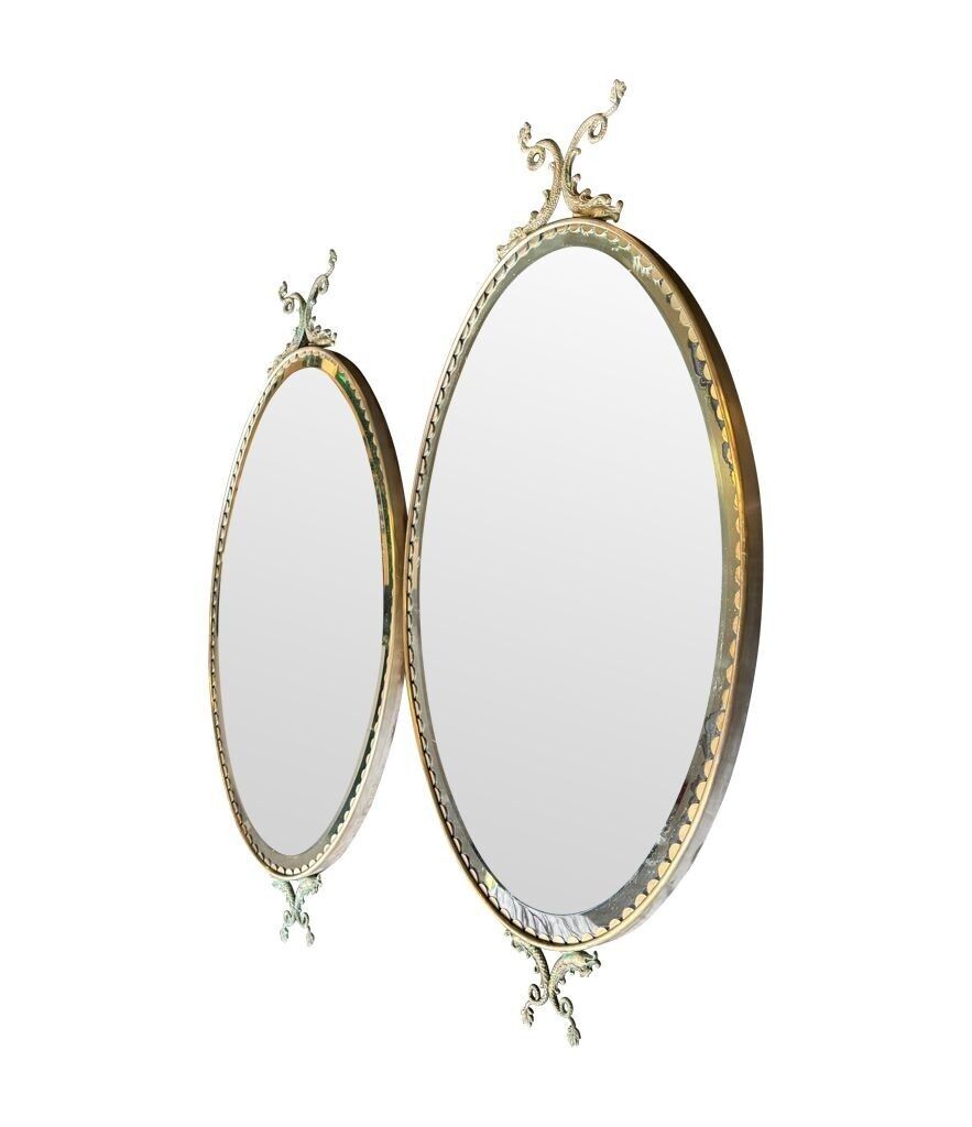 A Pair Of Italian 1940s Oval Mirrors With Dolphin Detailing Around The Brass Frame photo buy