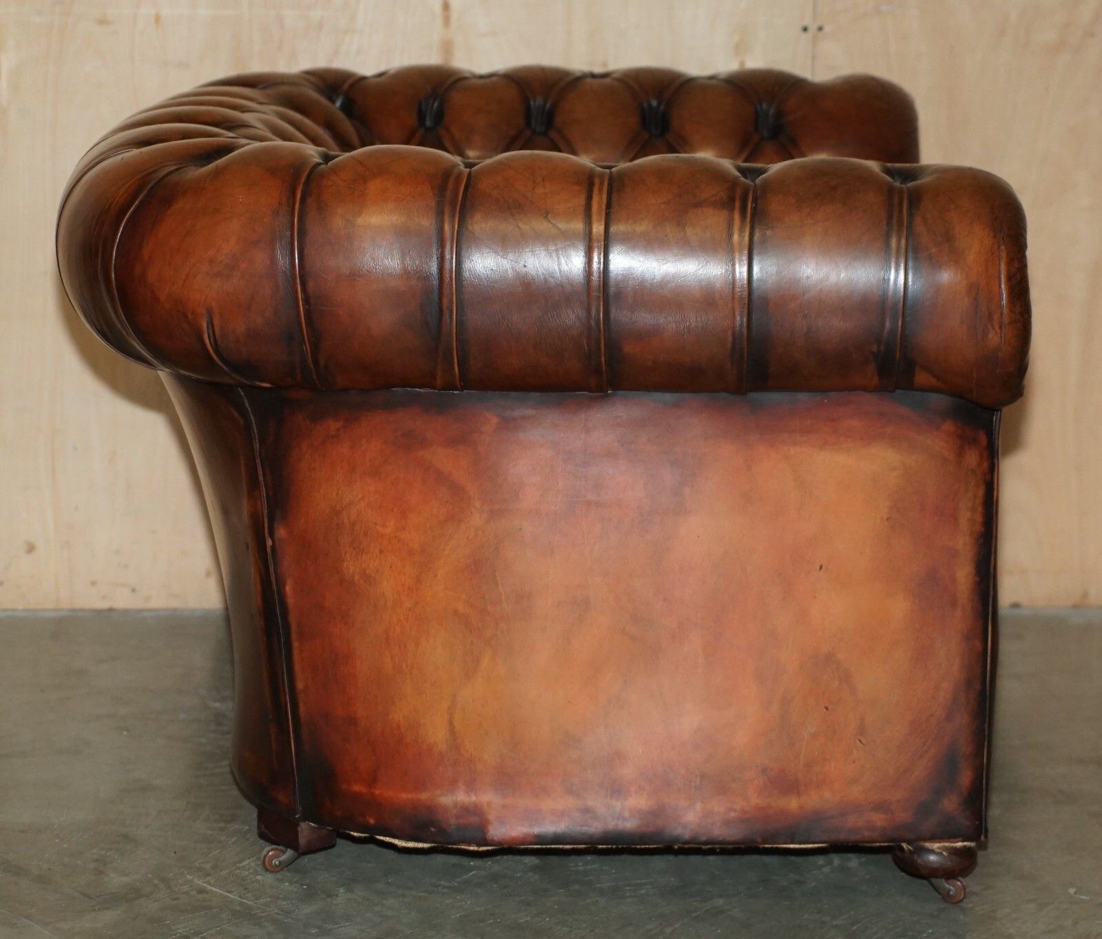 photo vinterior Restored Antique Chesterfield Club Armchair Brown Leather Porcelain Castors