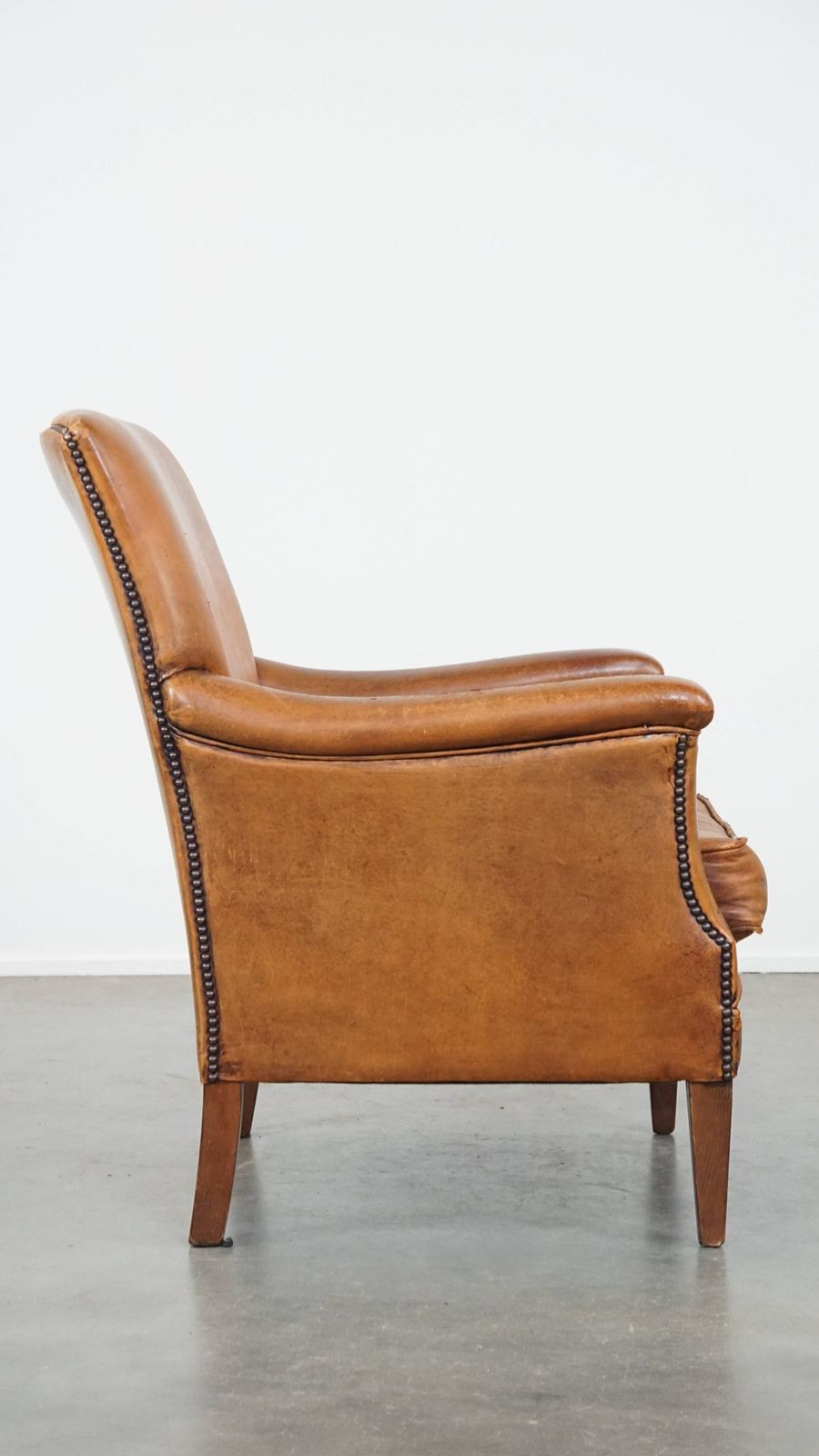 Karakteristieke En Comfortabele Fauteuil In Cognackleurig Schapenleer Met Strakke Vormen En Mooie Patina photo for sale
