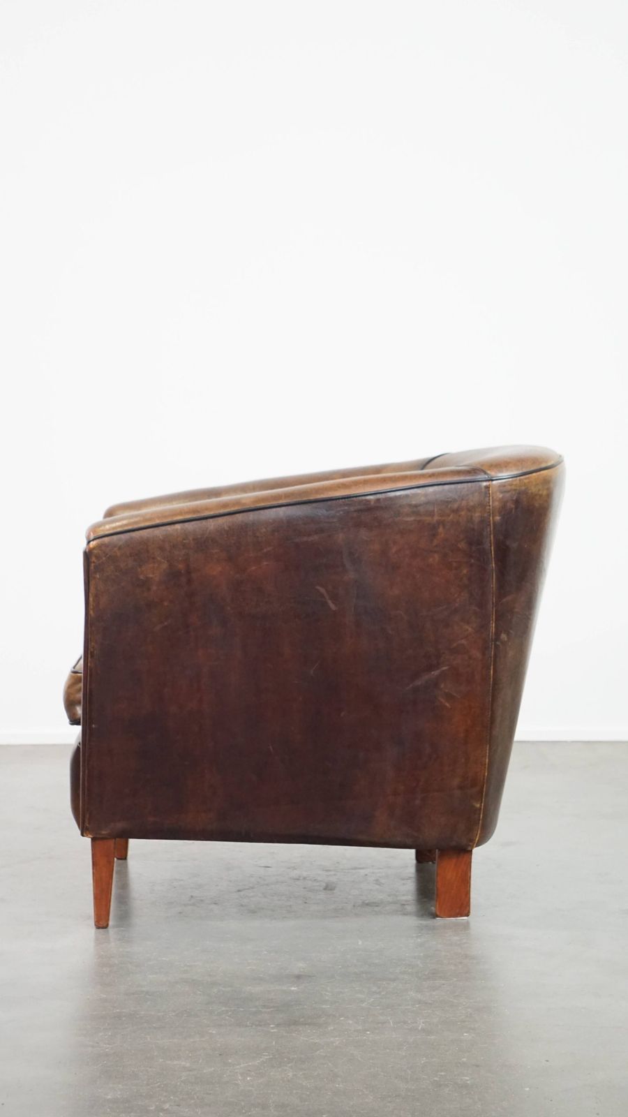 Dark And Sleek, Luxurious Sheepskin Club Chair With Beautiful Colours And A Black Piping Finish photo 929.4713999999999