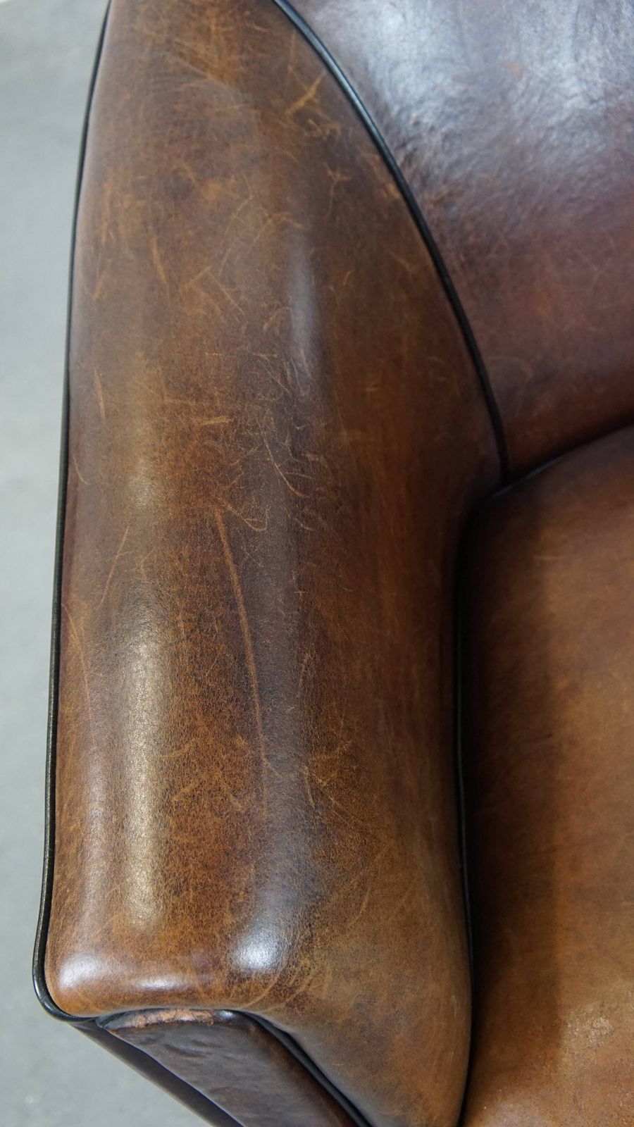 Dark And Sleek, Luxurious Sheepskin Club Chair With Beautiful Colours And A Black Piping Finish photo buy