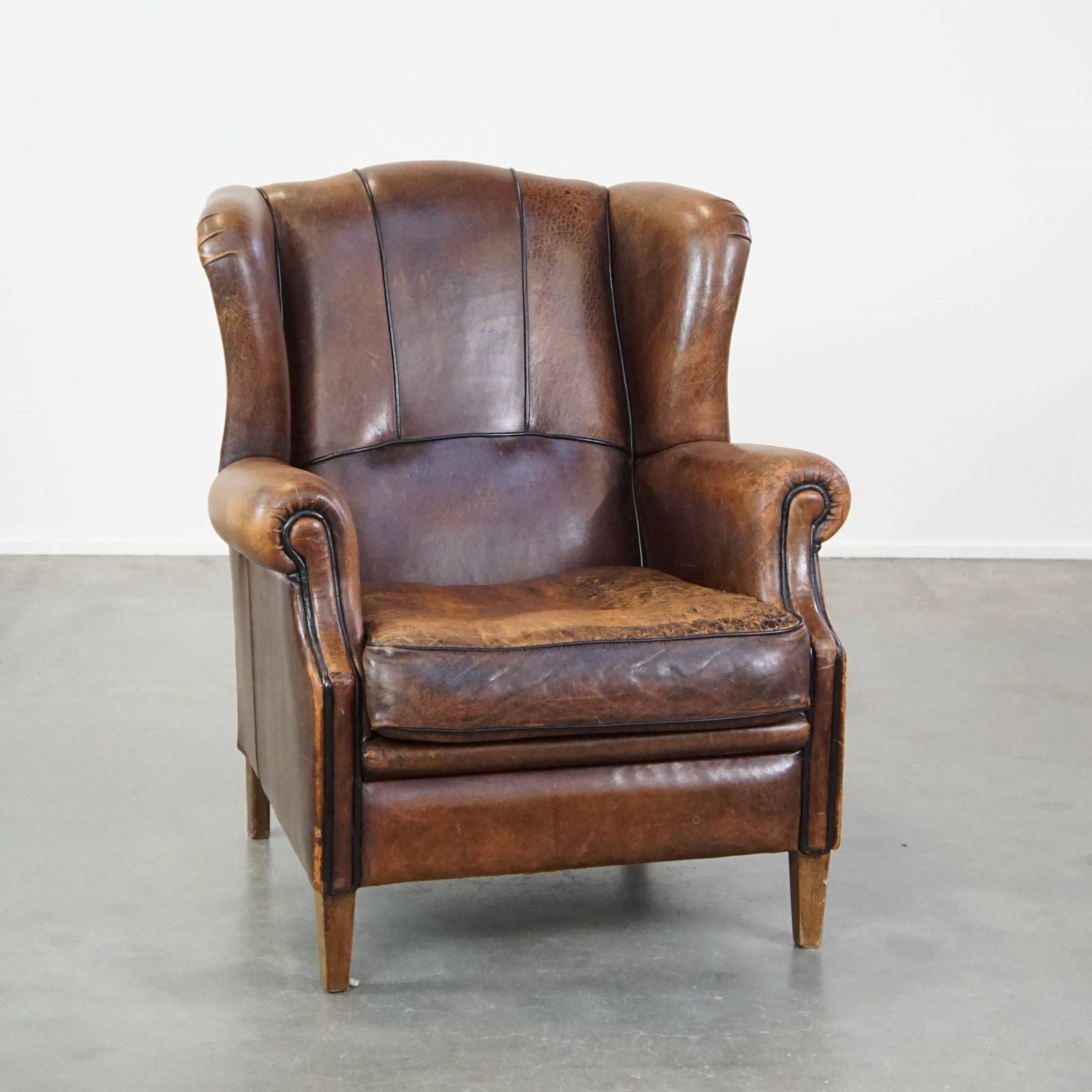Characteristic And Comfortable Sheepskin Wing Chair With A Beautiful Patina