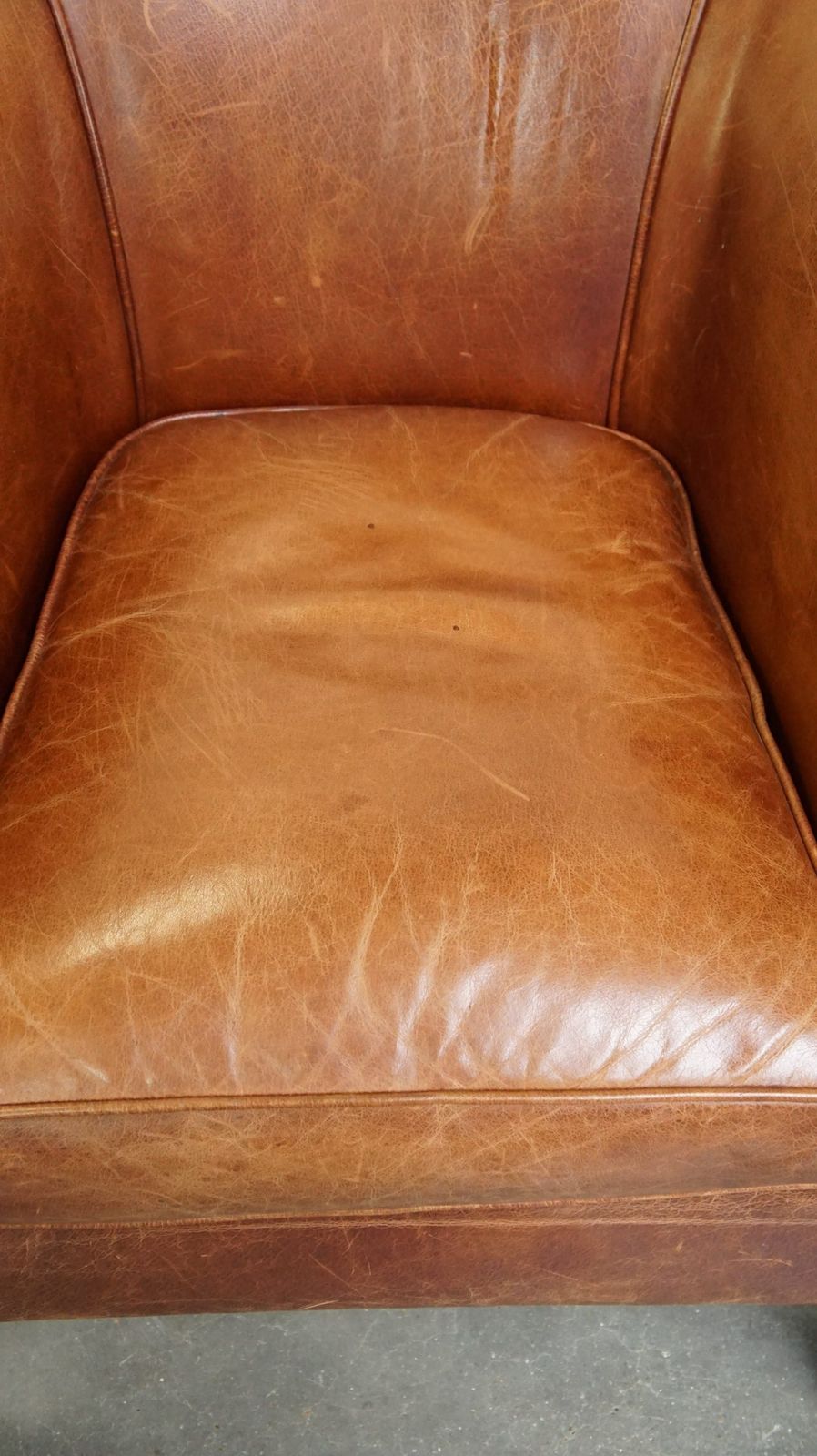 Very Comfortable, Elegant Cowhide Club Chair With A Loose Seat Cushion, Timeless Design And A Warm Color photo vinterior