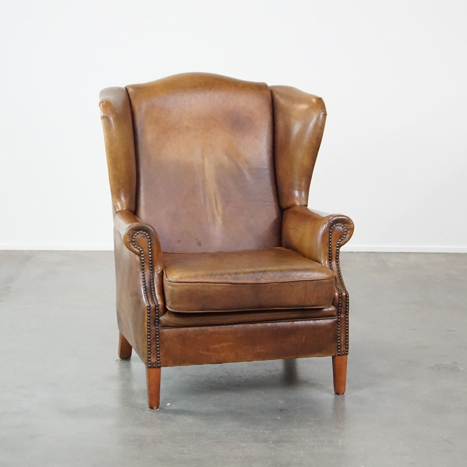 Charming Sheepskin Wing Chair With A Beautiful Patina And Good Seating Comfort