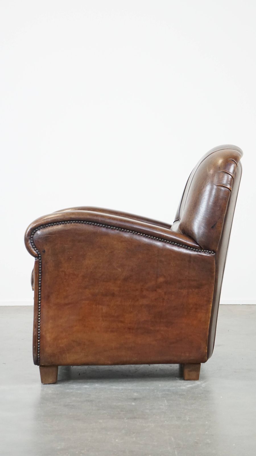 Royal And In Good Condition Dark Sheepskin Armchair With Round Shapes And A Comfortable Seat photo 1005.3023999999999