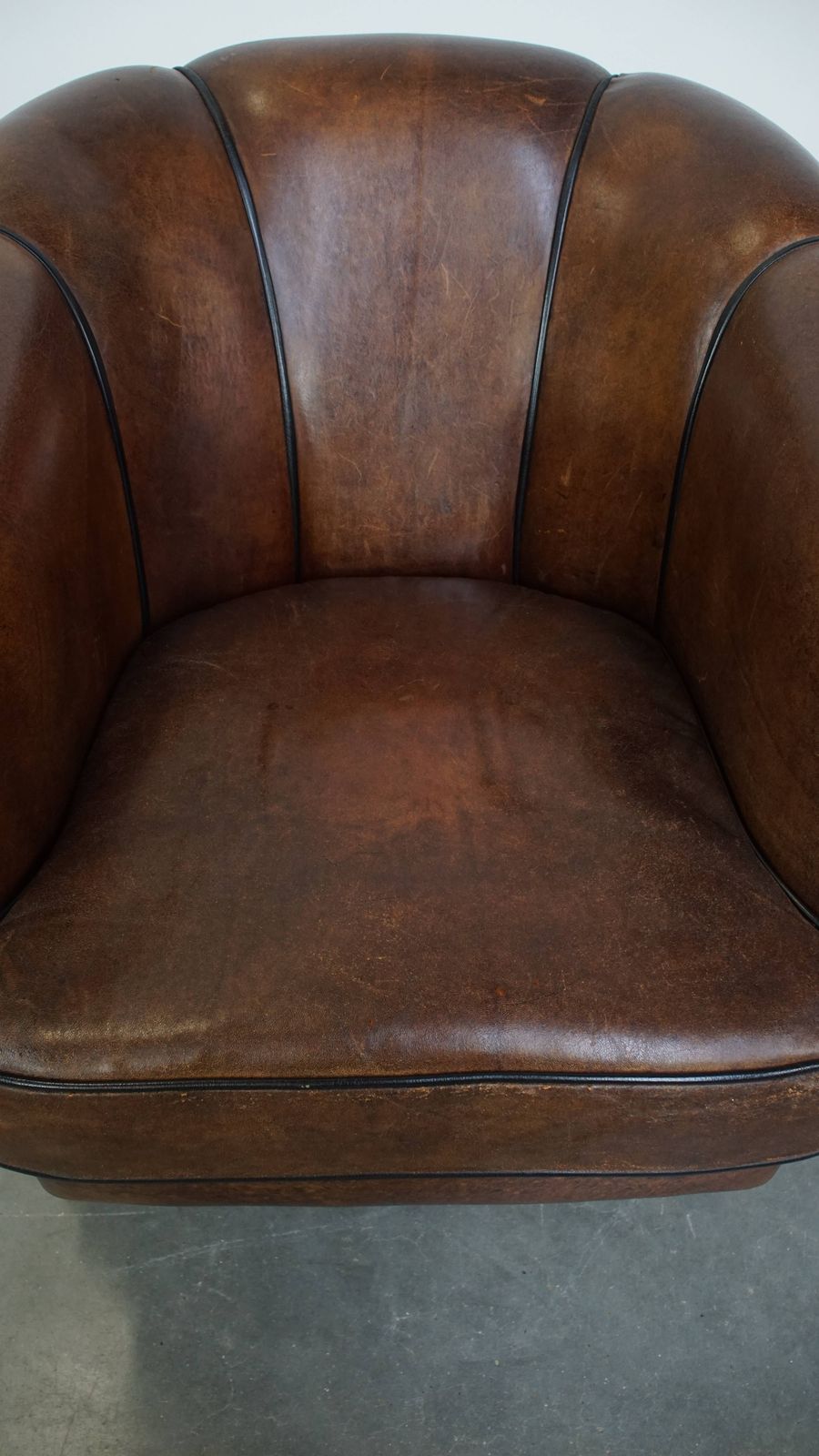 Special, Characteristic And Stately Dark Sheepskin Club Chair With A Black Piping Finish photo vinterior