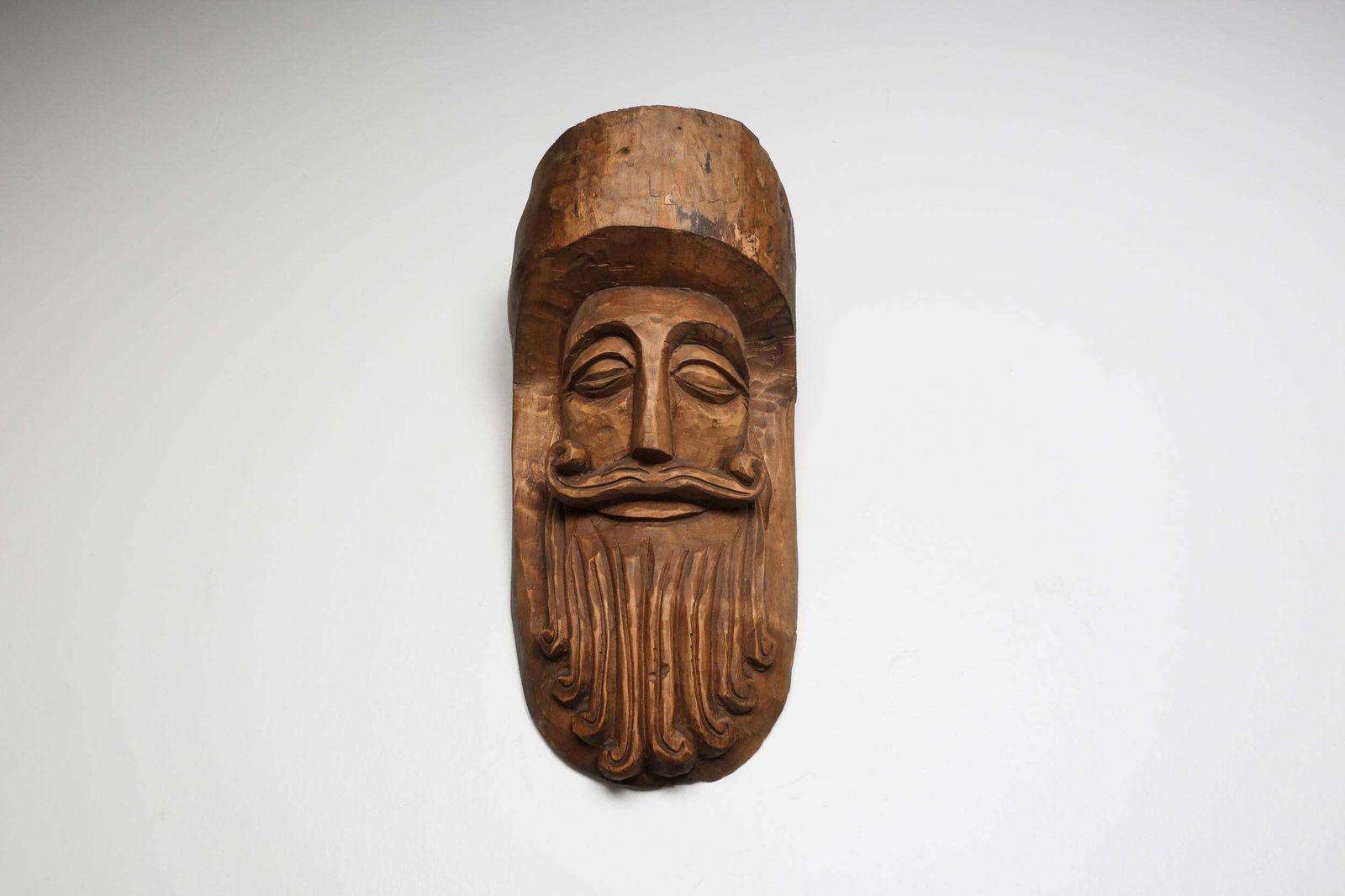 Hand Carved Rustic Wooden Mask With Soft Expression photo for sale