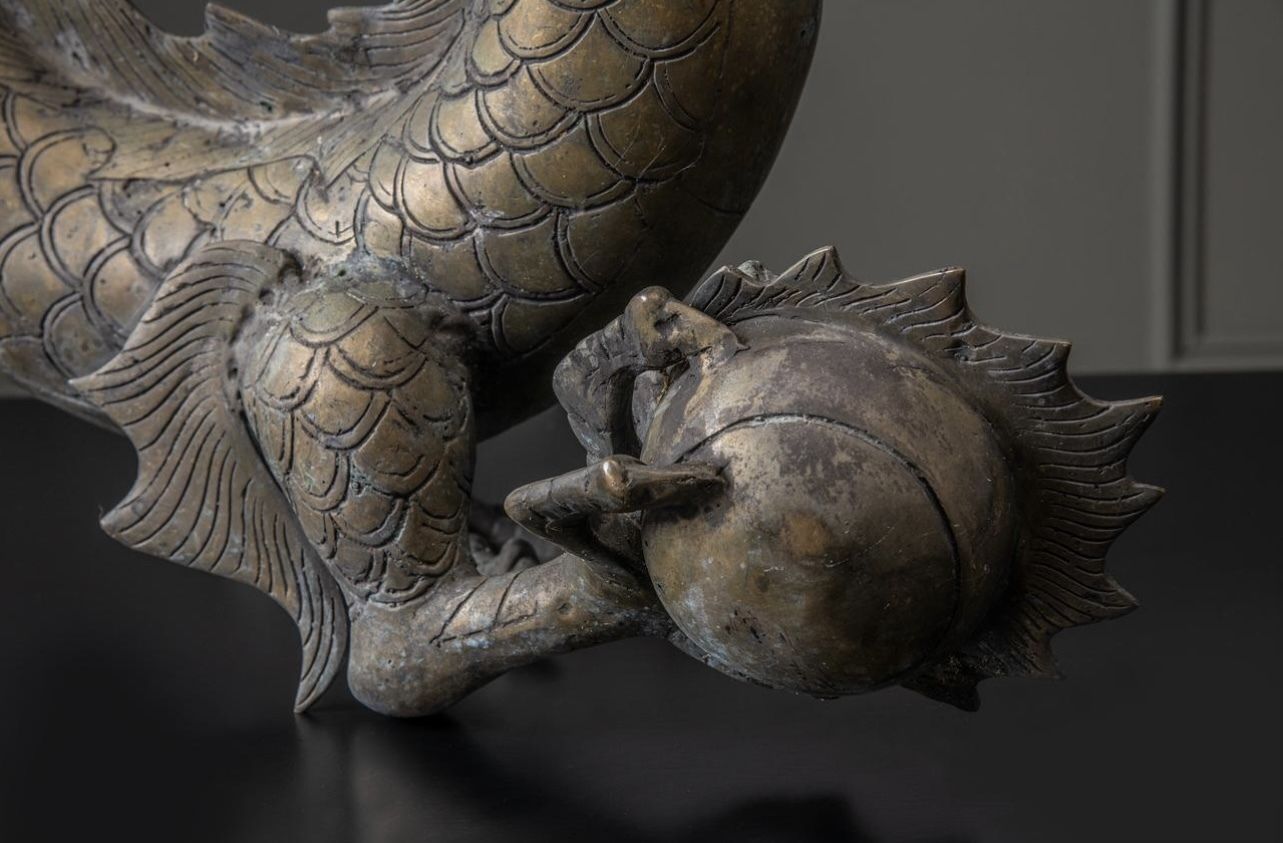 A Large Brass Dragon Chasing The Flaming Pearl Of Knowledge photo Art