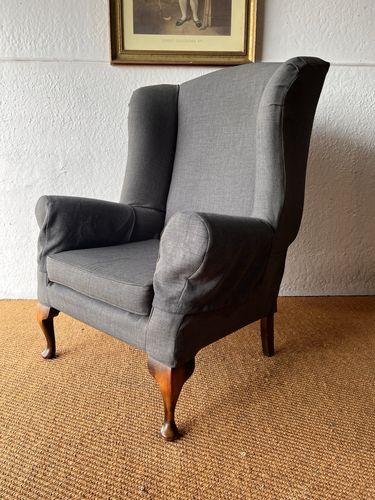 Large Comfortable Antique Wingback Chair With Clean Grey Coloured Loose Covers