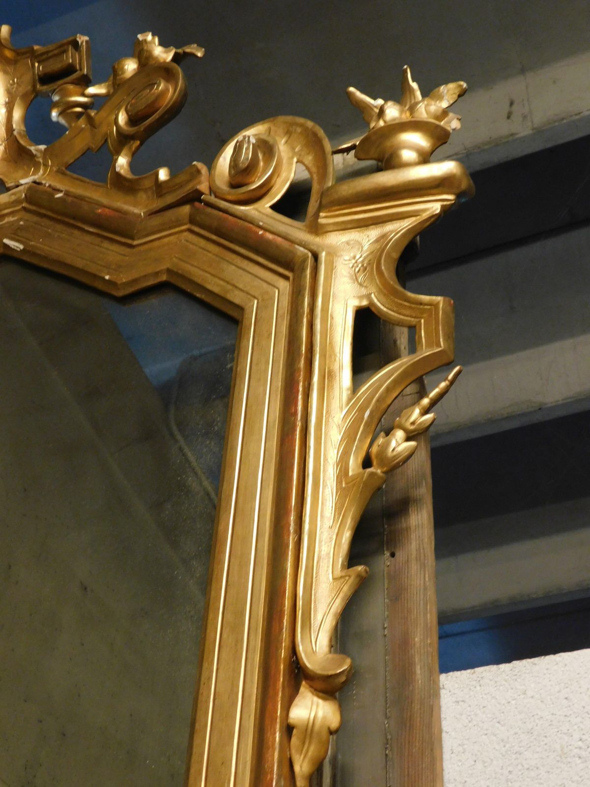 photo furniture Large Gilded Wooden Mirror With Carved Top Centered By A Coat Of Arms, Italy