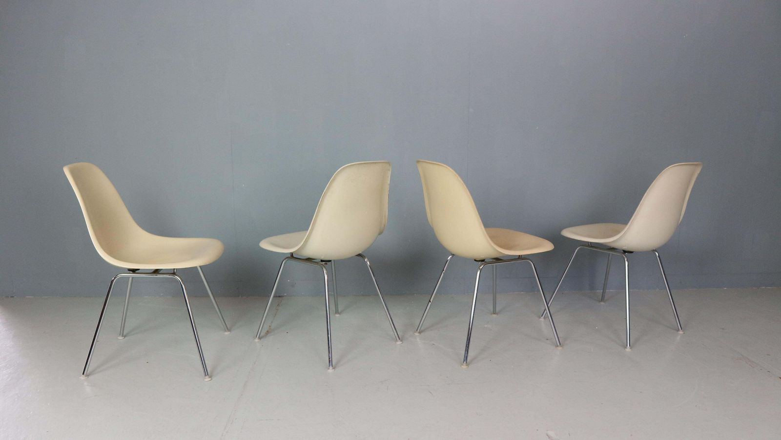 photo furniture Charles & Ray Eames Set Of 4 Off White "H Base" Chairs For Herman Miller, 1960