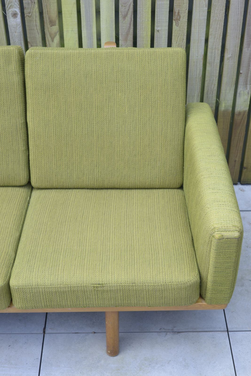 photo furniture Hans Wegner, Ge236 Getama Sofa. In Oak And Green Wool Upholstery. Danish, 1950s.