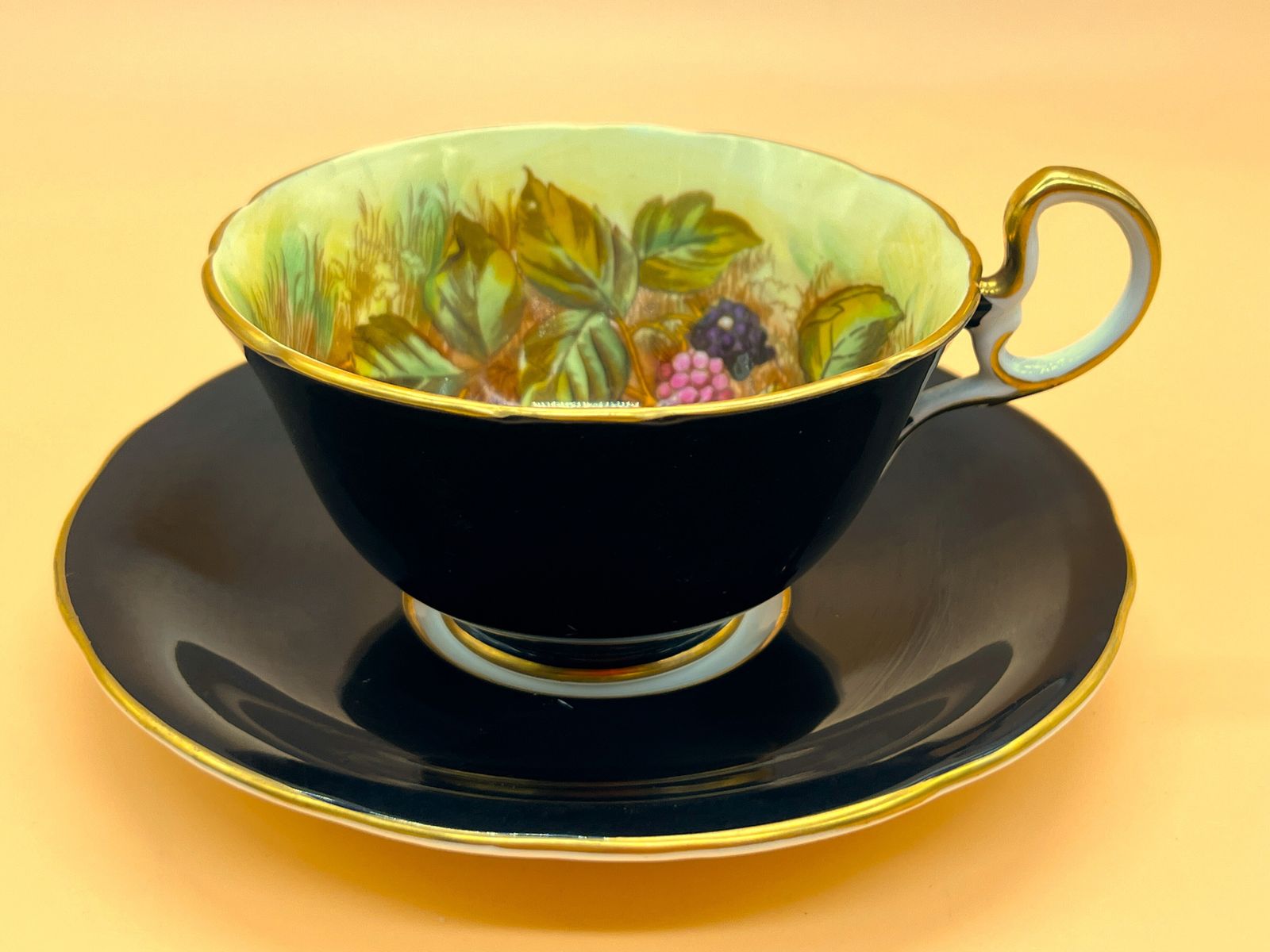 photo furniture Aynsley China Orchard Gold Fruit Signed D Jones High Doris Shape Black And Gold Cabinet Tea Cup & Saucer Duo. C1952 63.