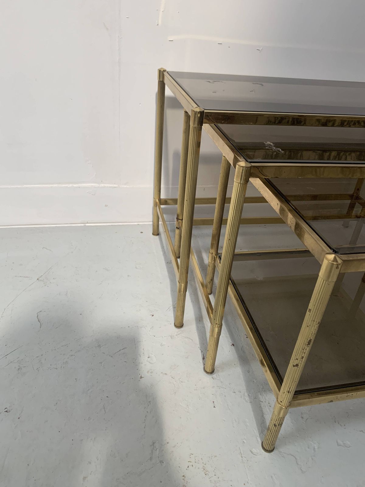 photo for sale Set Of Three Nesting Tables In Brass And Smoked Glass, 20th Century