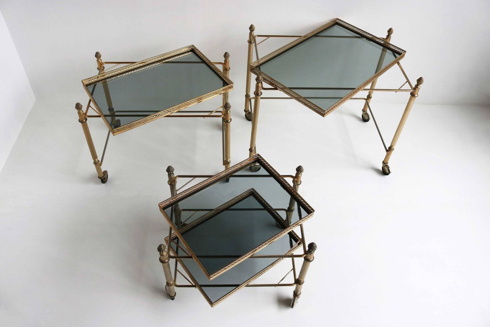 photo for sale Neoclassische Franse Bijzettafels In Maison Baguès Stijl – Mid Century Gerookt Glas, Set Van 3 Vintage Bijzettafels Op Wieltjes, Ca. 1960