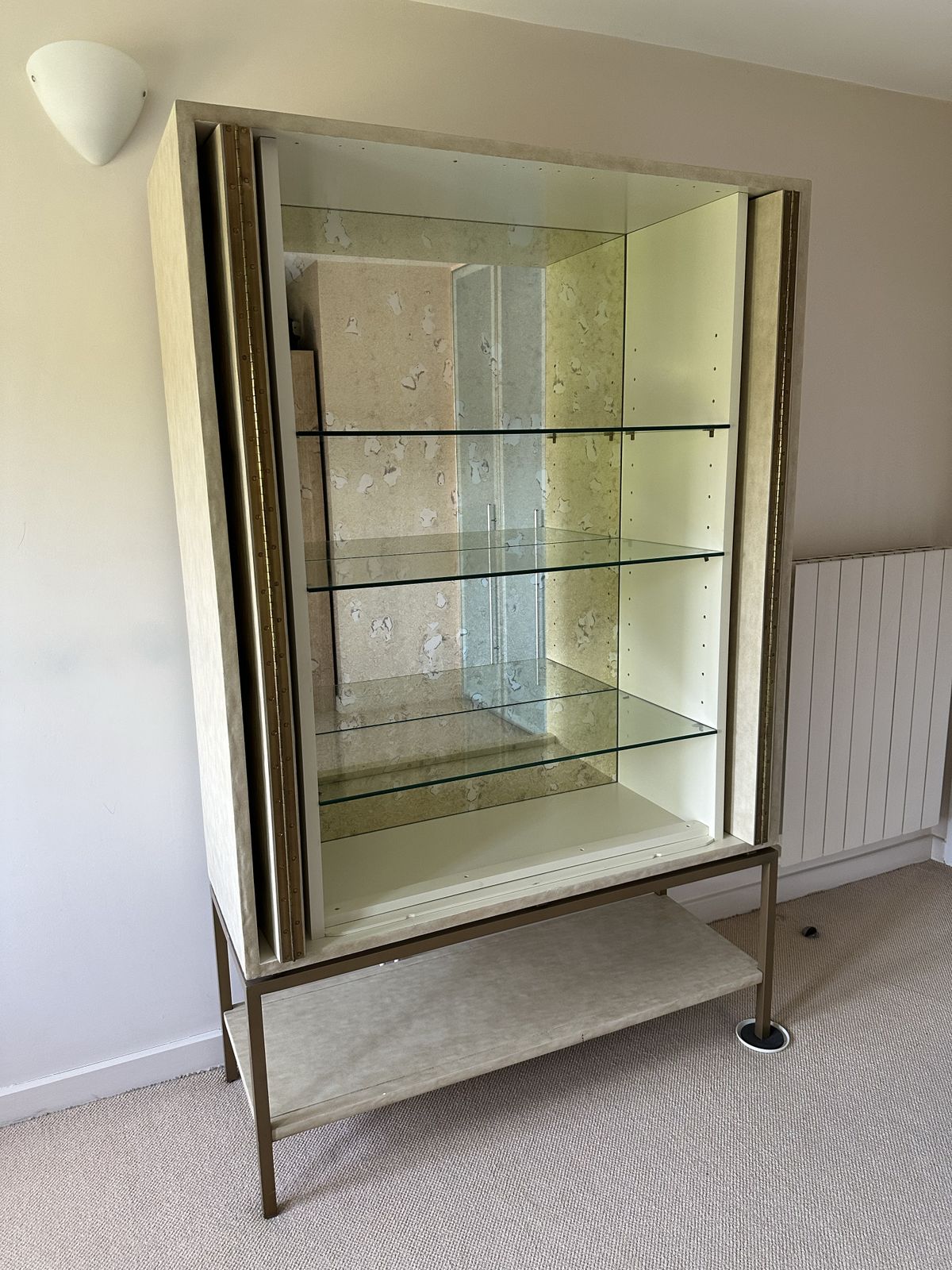 A Gorgeous Drinks Cabinet With Beautiful Panelled Doors And A Gilded Metal Base. Inside It Has An Ornate Mirrored Back With Glass Shelves For A Special Display. The Doors Can Be Neatly Folded Away. photo for sale
