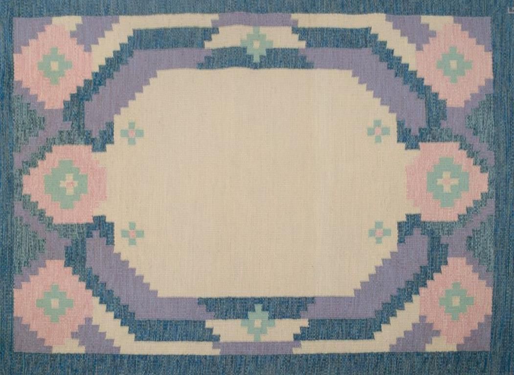 Swedish Carpet In Pure Wool. Geometric Pattern In Blue, White, And Pink Colors. photo Textiles