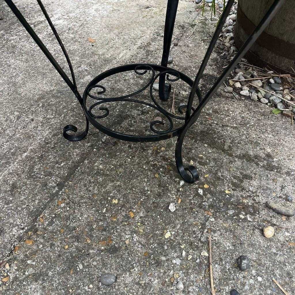 photo furniture Black Metal Circular Garden Table Faded Clock Face Tripod Legs Ornate Shelf