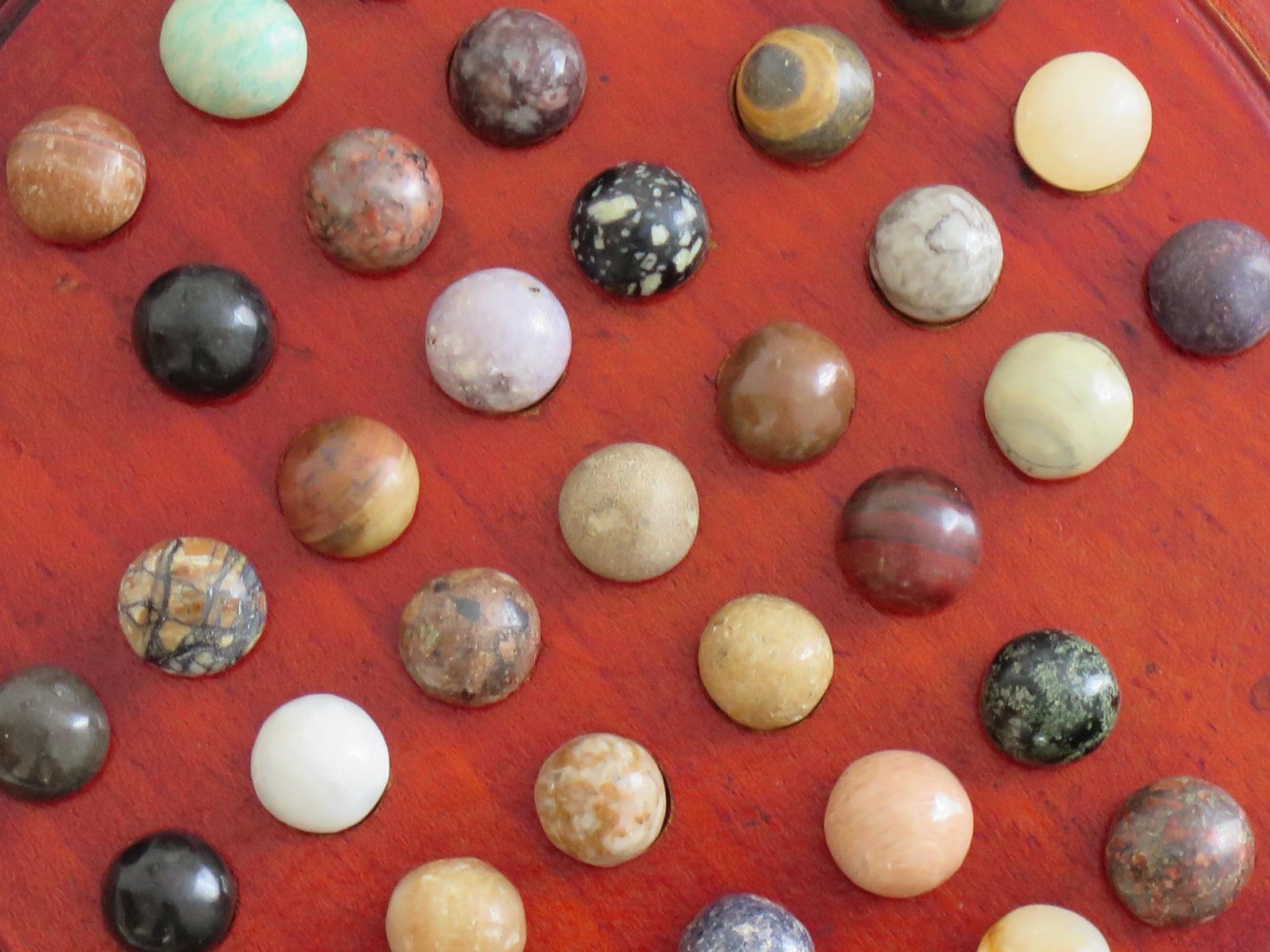 photo for sale Marble Solitaire Game With Hardwood Board And 33 Agate Stone Marbles, Circa 1925