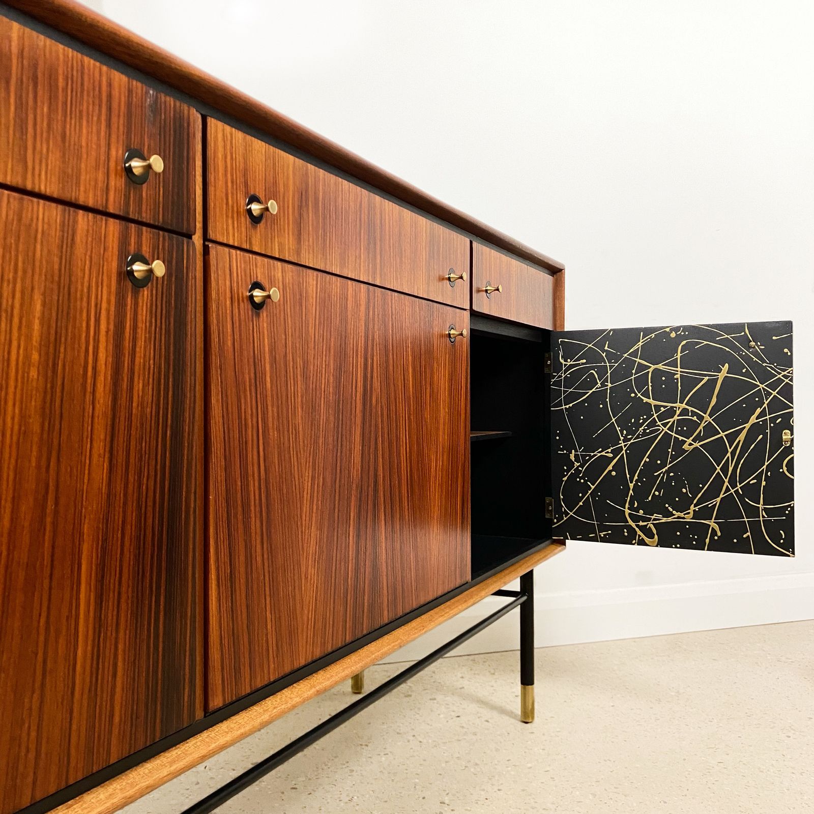 1985.0 Mid Century Cocktail Bar Drinks Cabinet By Heal's In Rosewood And Brass With Black & Gold Jackson Pollock Paint Effect photo