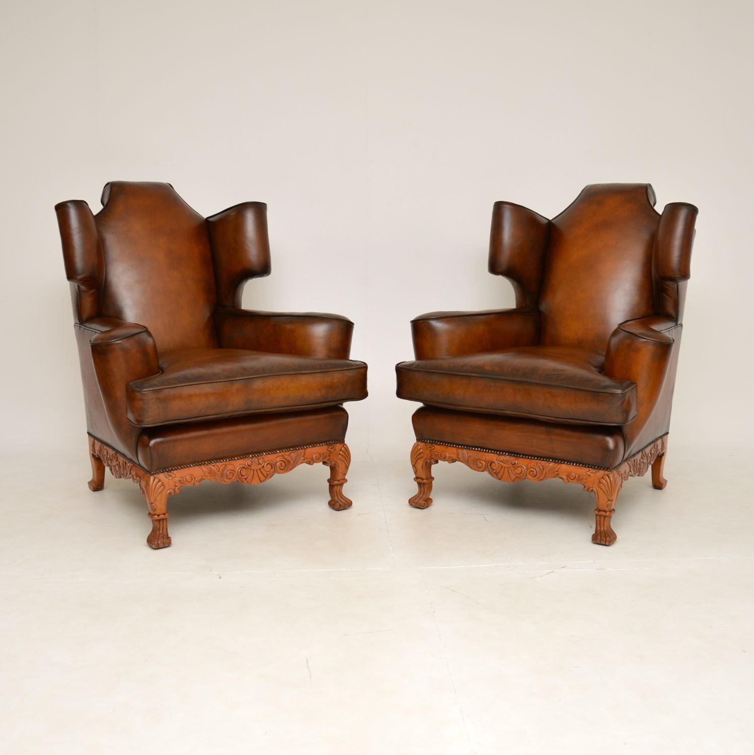 Pair Of Antique Leather Wing Back Armchairs