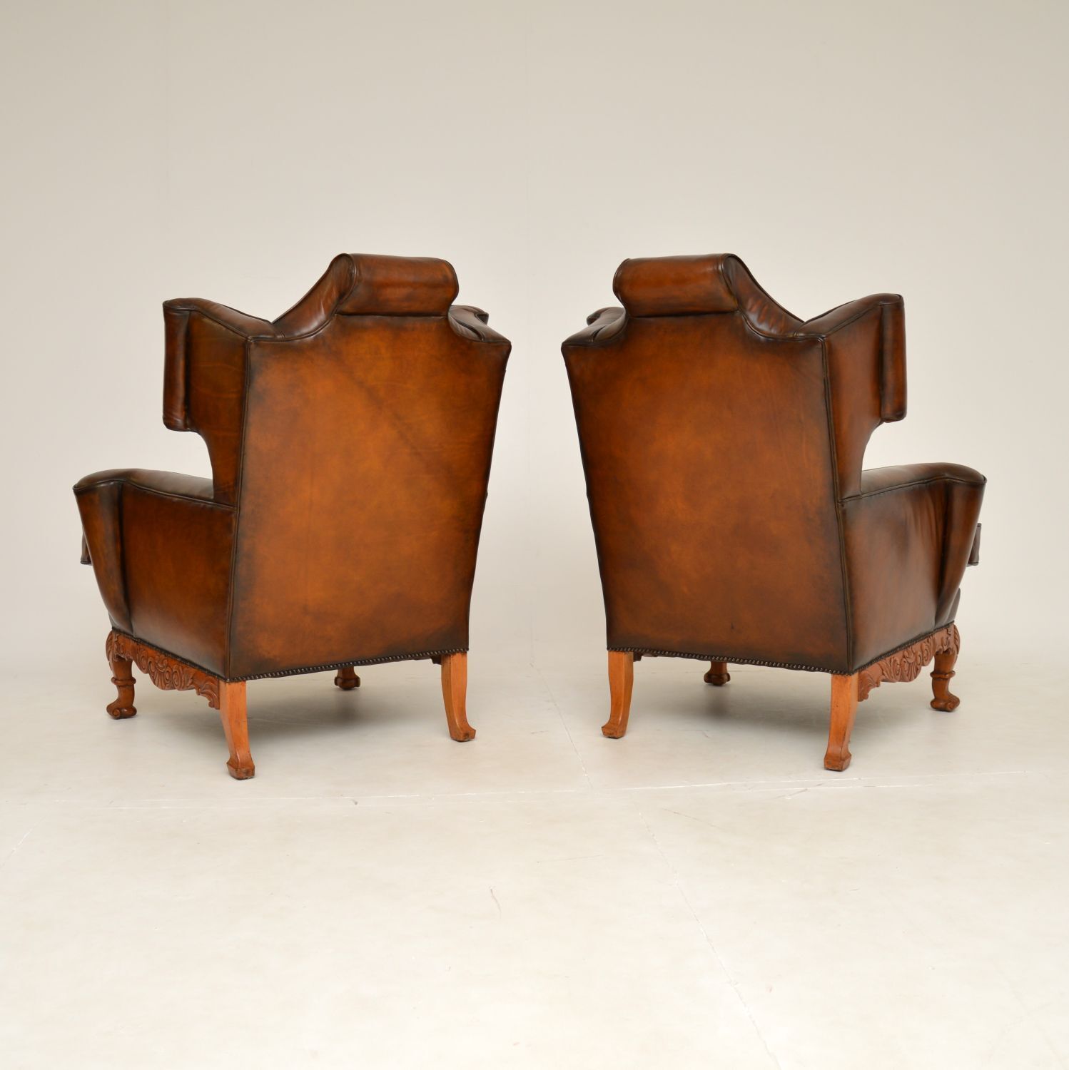 photo for sale Pair Of Antique Leather Wing Back Armchairs