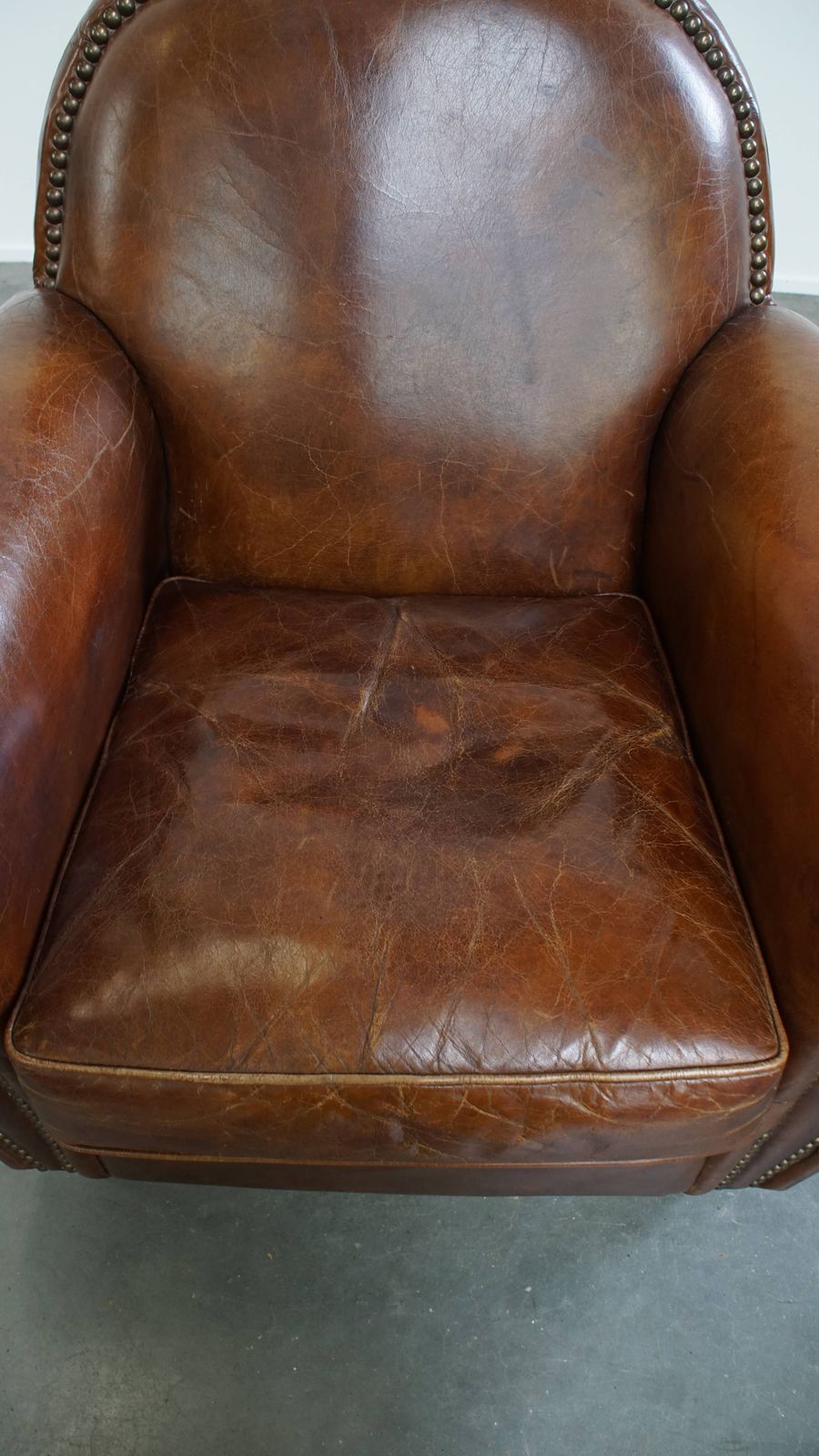 Characterful And Timeless Cowhide Design Armchair With Beautiful Round Shapes And Decorative Nails photo vinterior