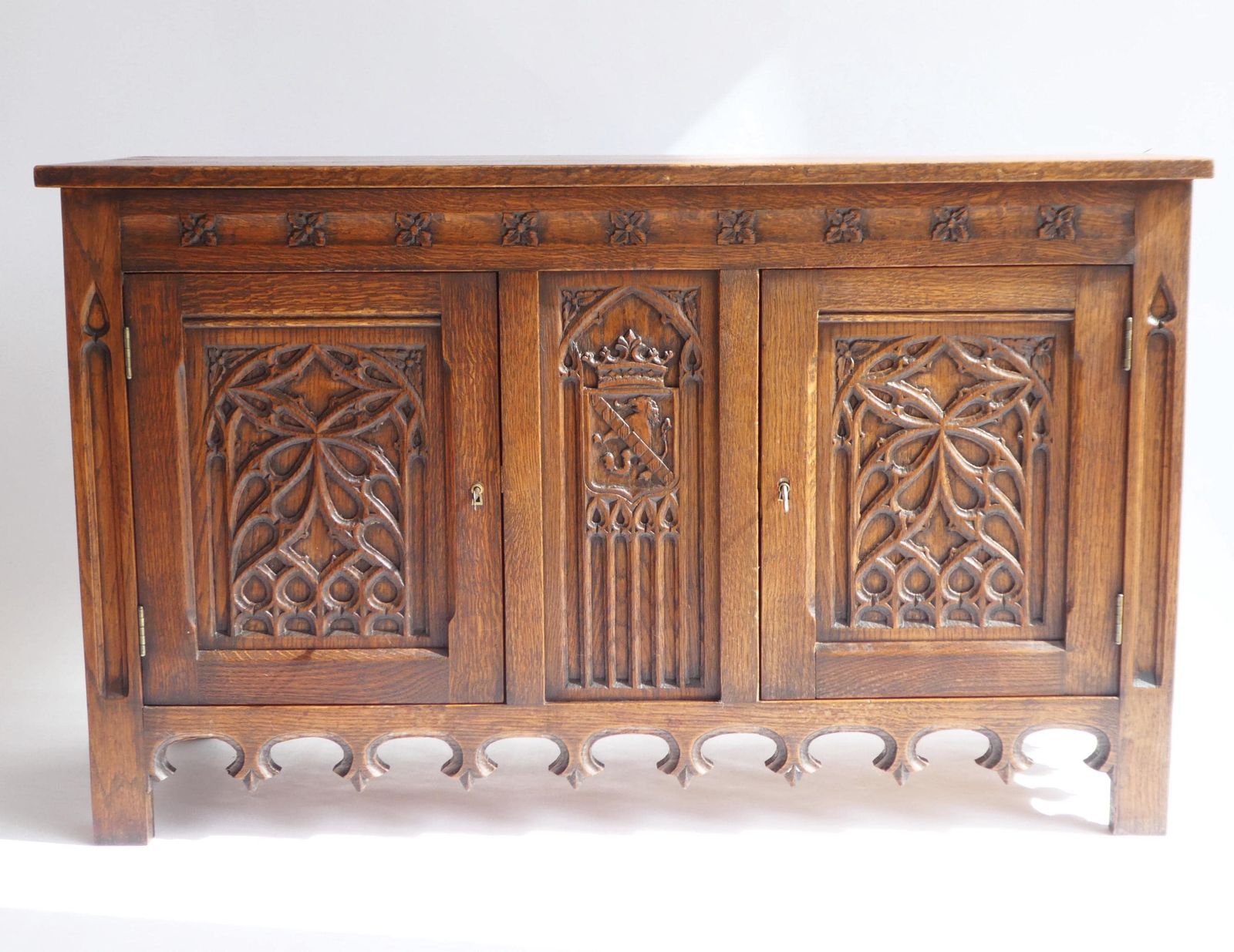 Antique Gothic Wooden Credenza, Hand Carved Cabinet With Doors And Lock, 19th Century Medieval Cupboard With Lion And Church Window Panels photo for sale