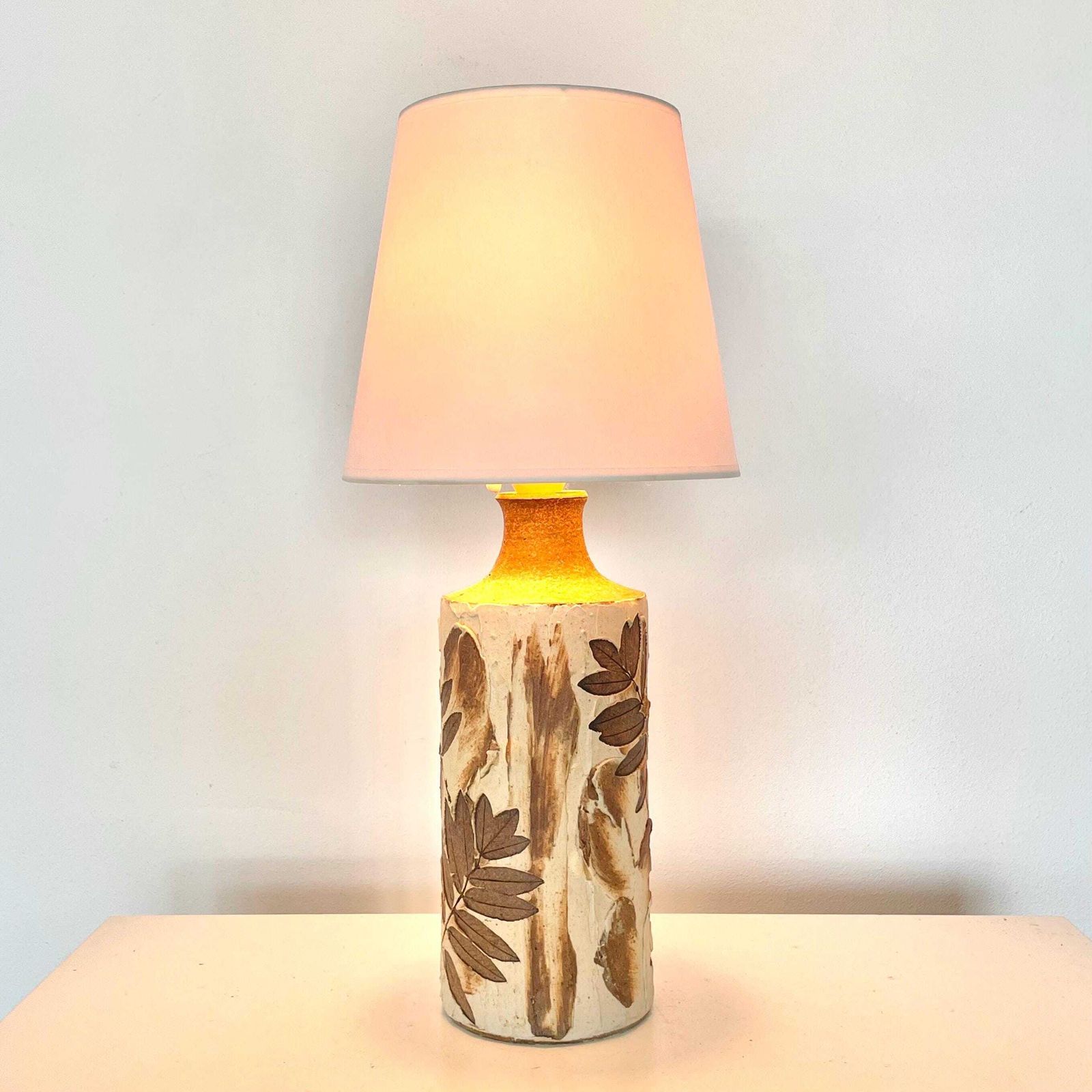 Ceramic Mid Century Table Lamp From Denmark With Plant Pattern And Earthy Colors With A White Fabric Shade