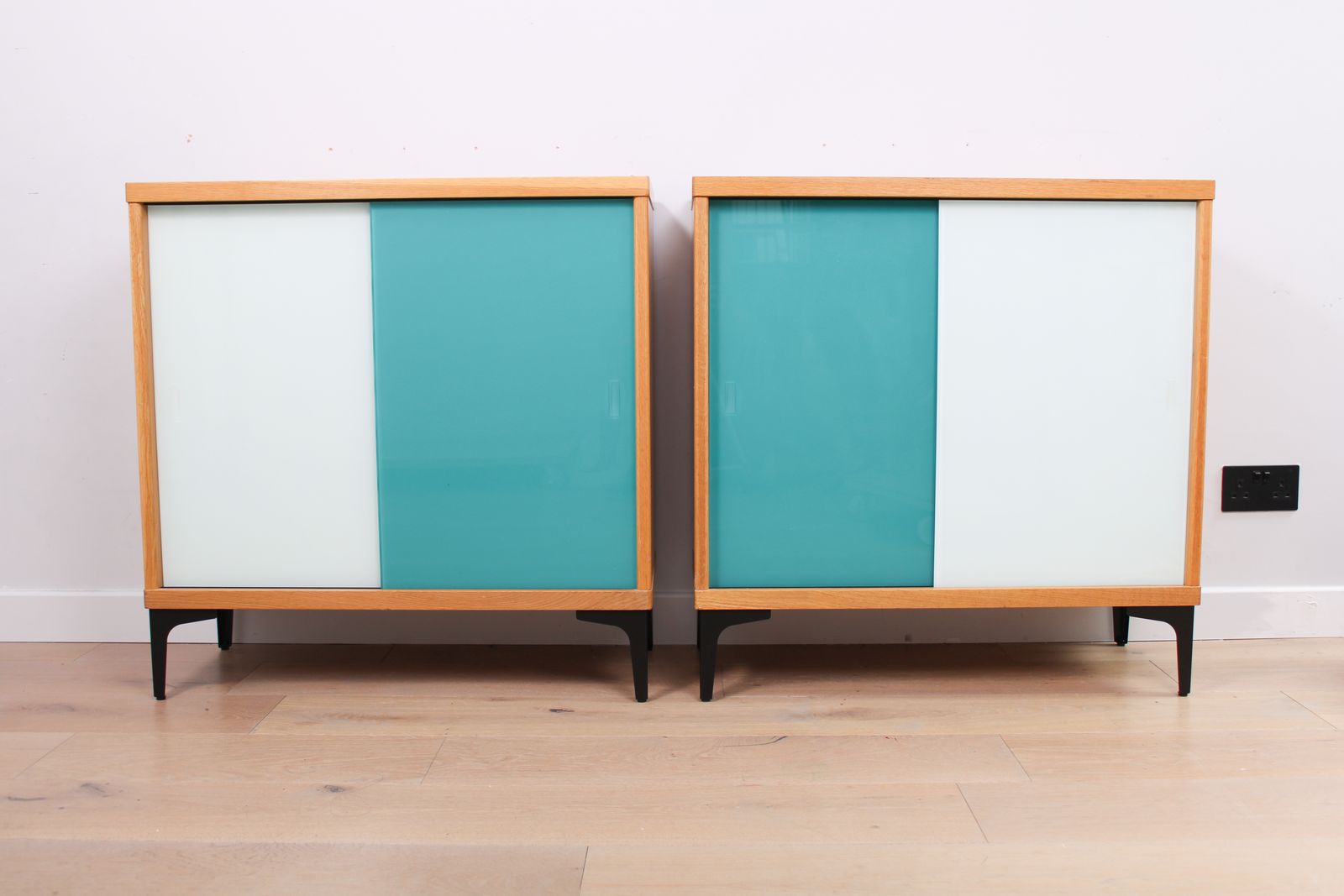 A Vintage Mid Century Bookcase With Teal And White Sliding Doors 1 Of 2