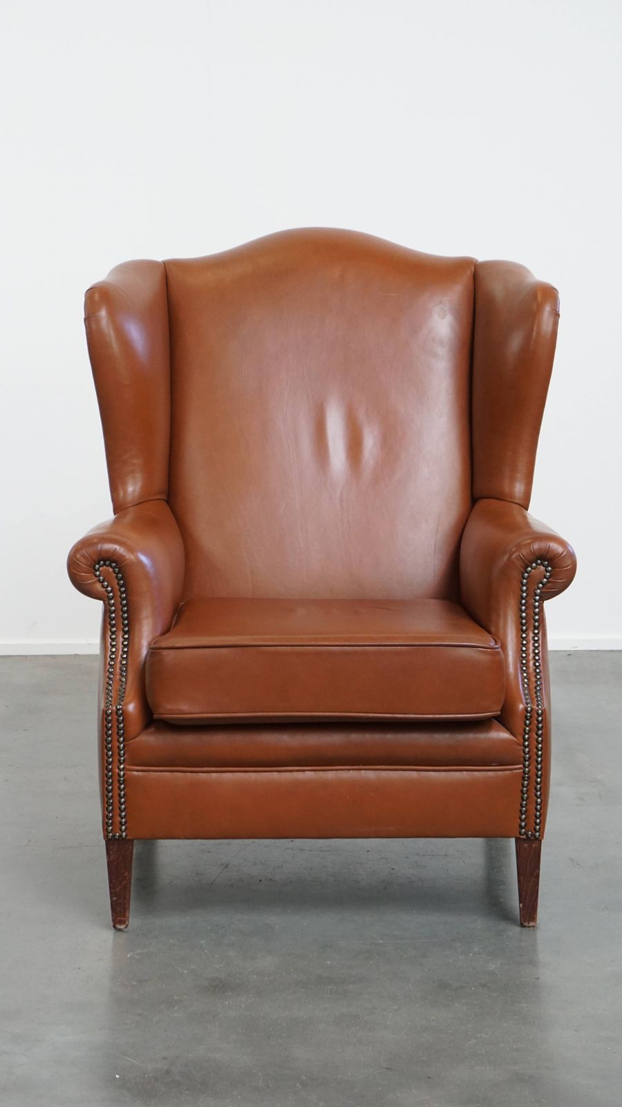 Stylish And In Good Condition Cognac Colored Cowhide Armchair In English Style With Decorative Nails photo furniture