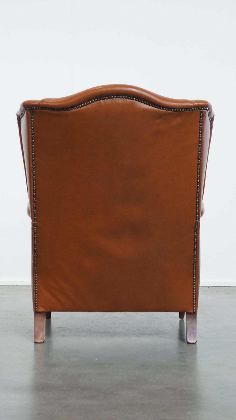 Stylish And In Good Condition Cognac Colored Cowhide Armchair In English Style With Decorative Nails photo Furniture