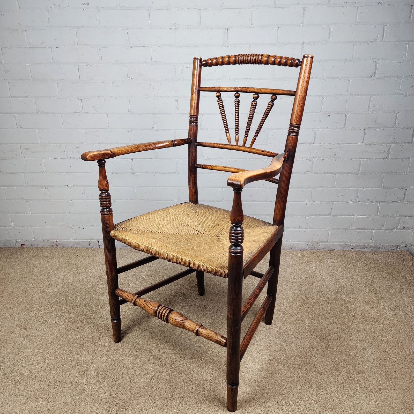 photo furniture A George III Elm And Fruitwood Spindle Back Carver Chair