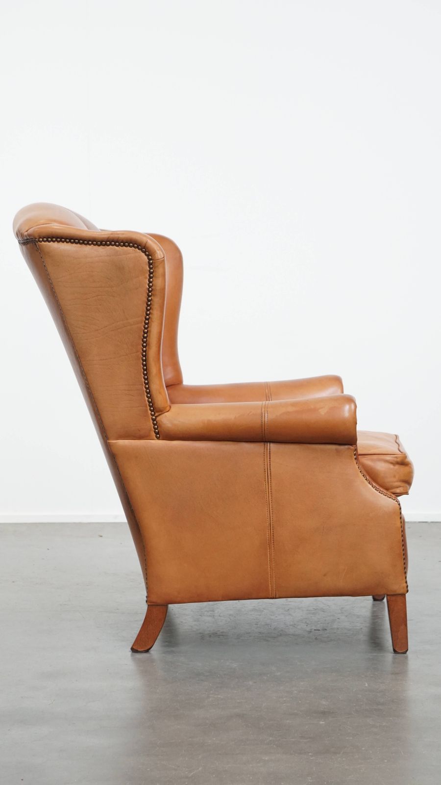 Classic And Unique Cowhide Wing Chair Finished With Decorative Nails And Beautiful Details photo for sale