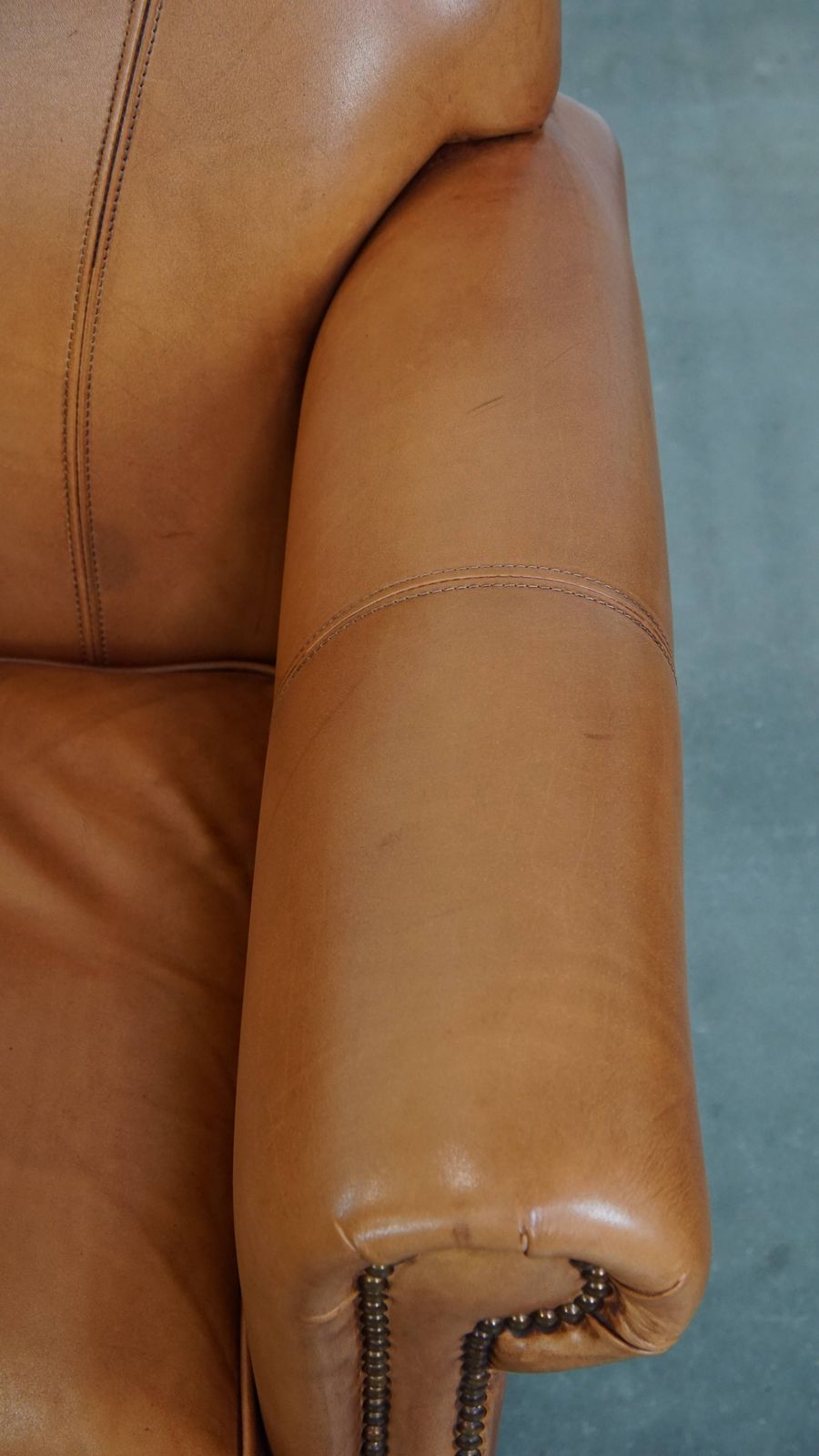 Beautiful And Comfortable Cowhide Leather Armchair In A Warm Cognac Color Finished With Decorative Nails photo vintage