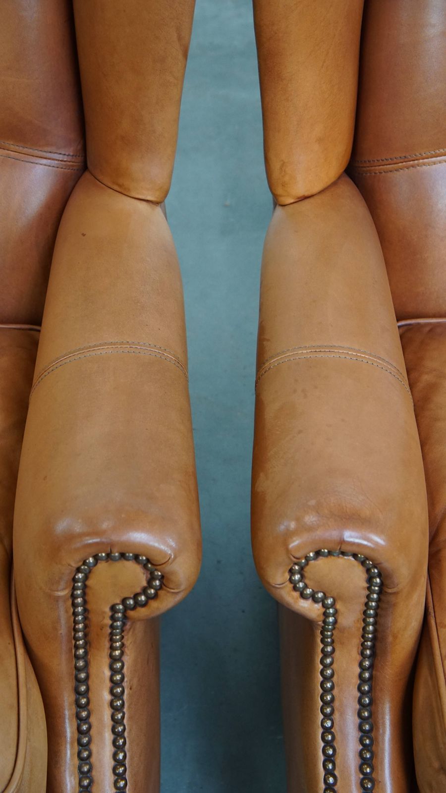 Classic And Unique Set Of 2 Cowhide Wing Chairs Finished With Decorative Nails And Beautiful Details photo vintage