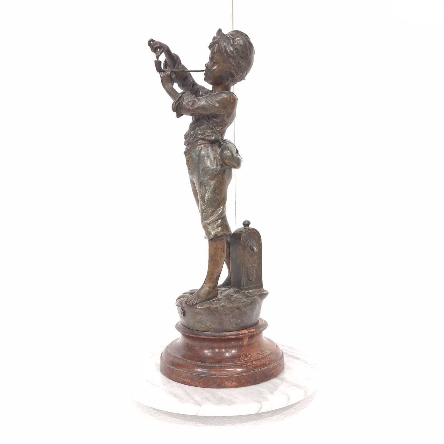 A French Spelter Statue Of A Boy Lighting A Pipe