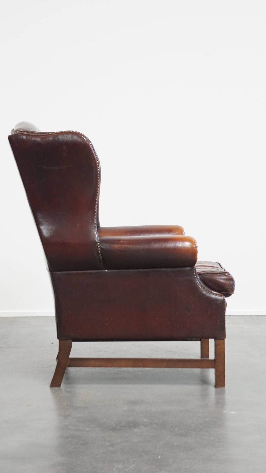 Luxurious, Classic And Comfortable Dark English Style Sheepskin Wing Chair With Lots Of Character And A Beautiful Patina photo for sale