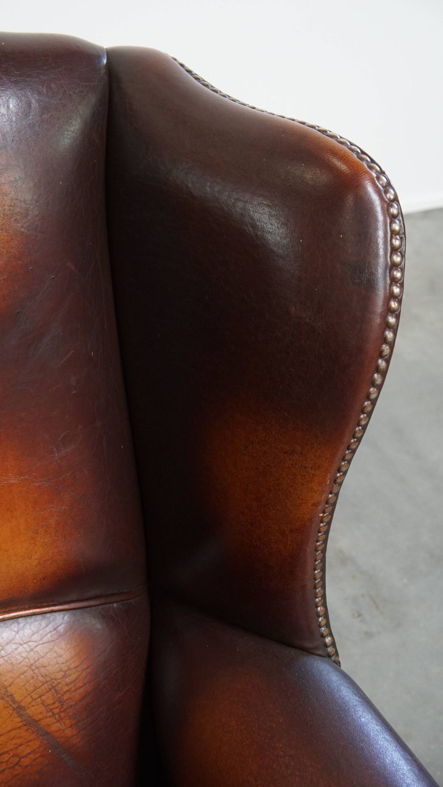 Furniture Luxurious, Classic And Comfortable Dark English Style Sheepskin Wing Chair With Lots Of Character And A Beautiful Patina photo