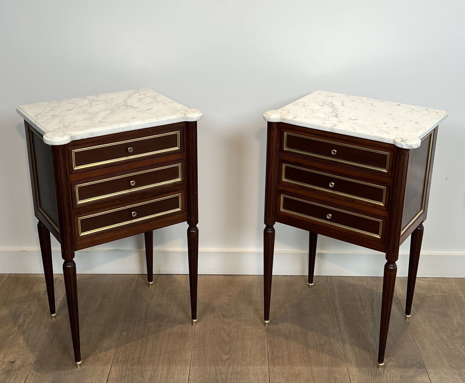 Pair Of Mahogany And Brass End Tables Or Bedside Tables With Carrara Marble Tops In The Style Of Maison Jansen. Circa 1940