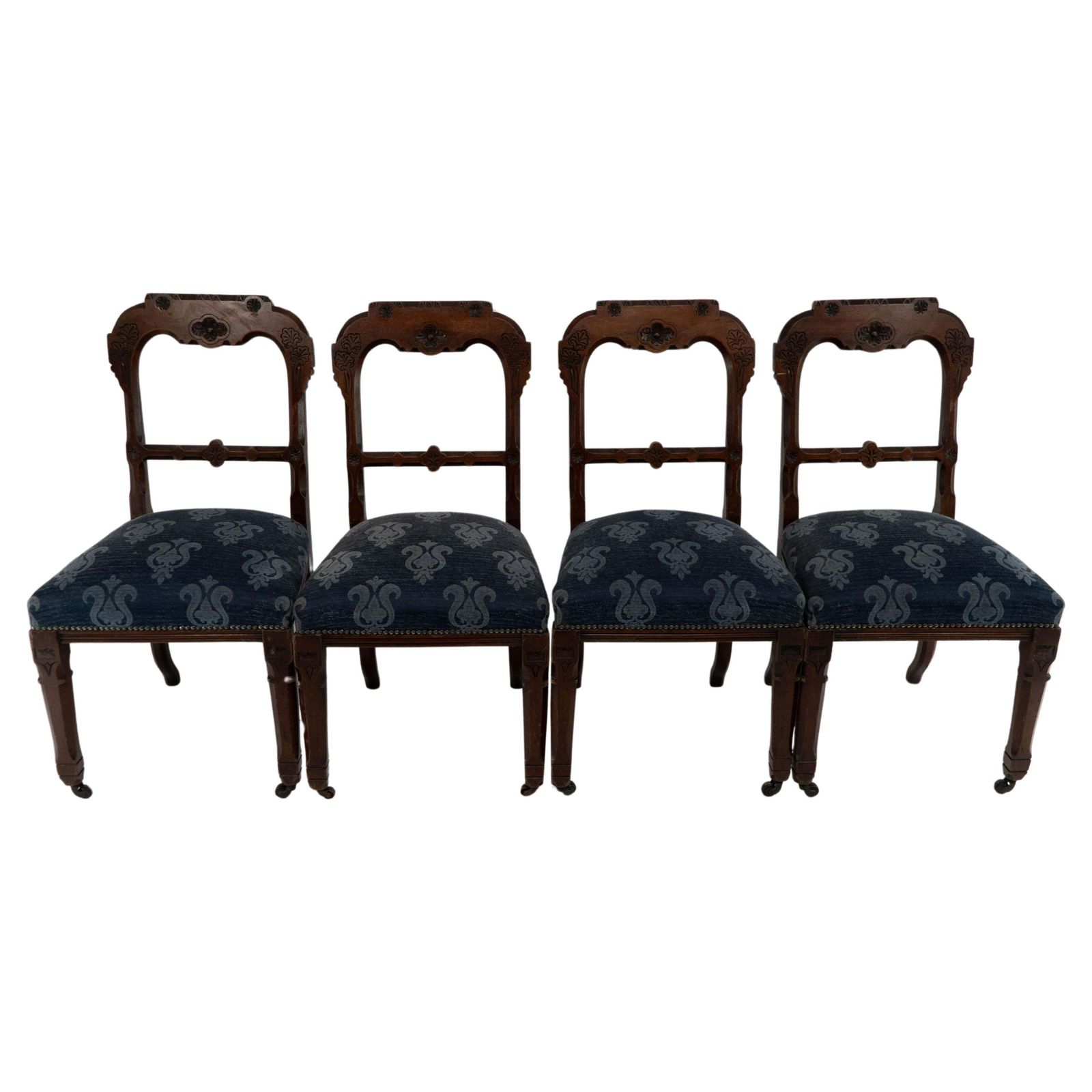 A Set Of Four Aesthetic Movement Oak Dining Chairs With Carved Decoration