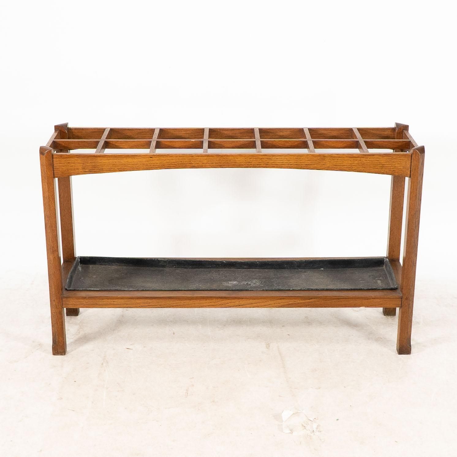 An Arts And Crafts Oak Stick And Umbrella Stand With Fourteen Sections photo furniture