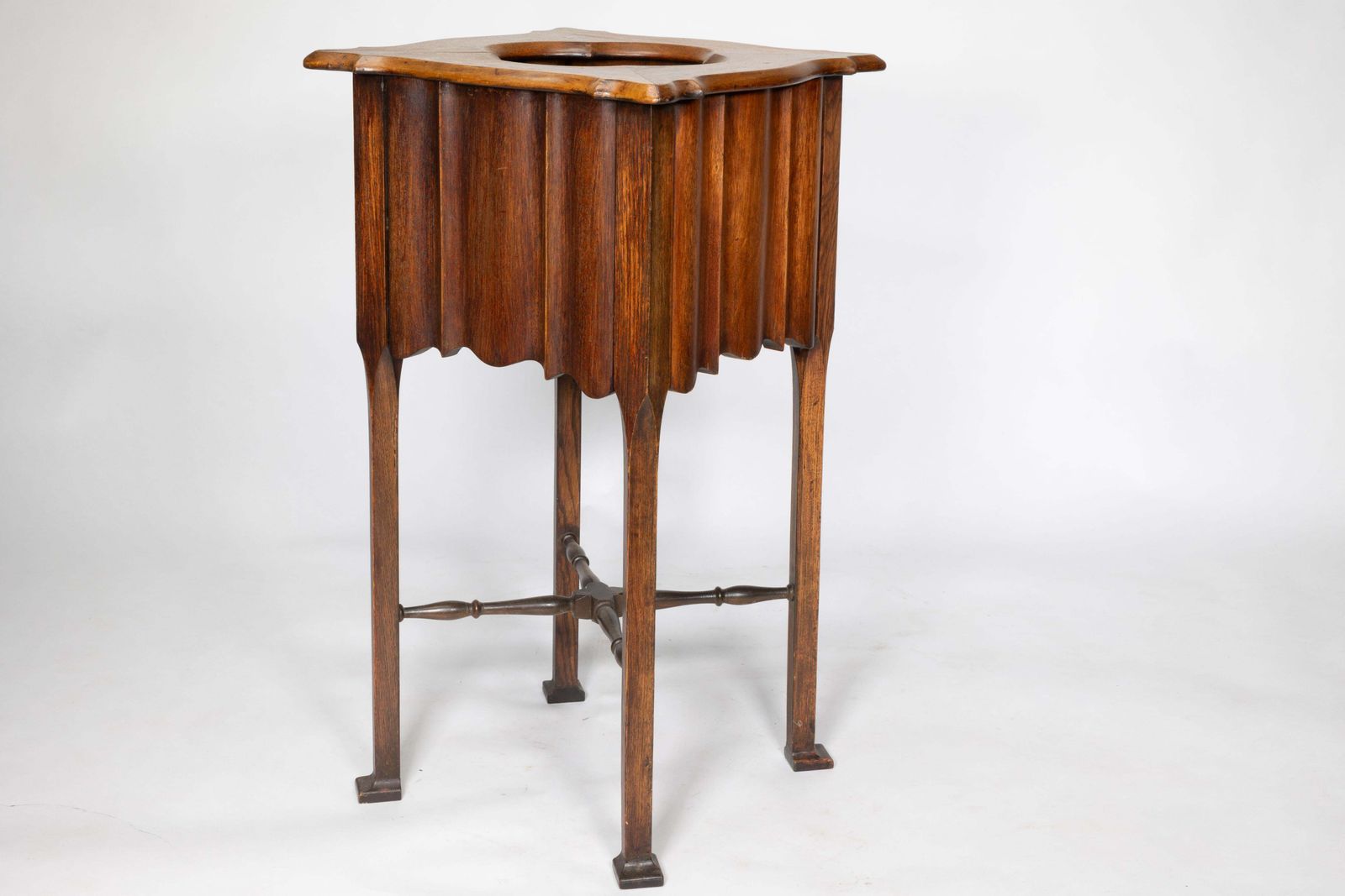 An Arts And Crafts Walnut Plant Stand With A Shaped Top And Ribbed Style Sides photo buy