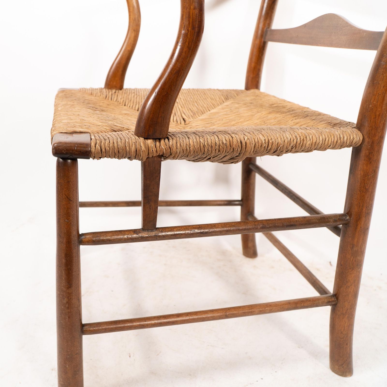 3875.0 C R Ashbee. An Arts And Crafts Rush Seat Ladder Back Armchair photo