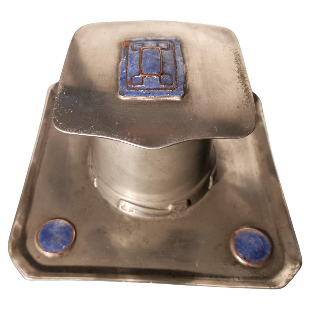Liberty & Co. An Arts & Crafts Pewter Inkwell With Violet Enamel Decoration.